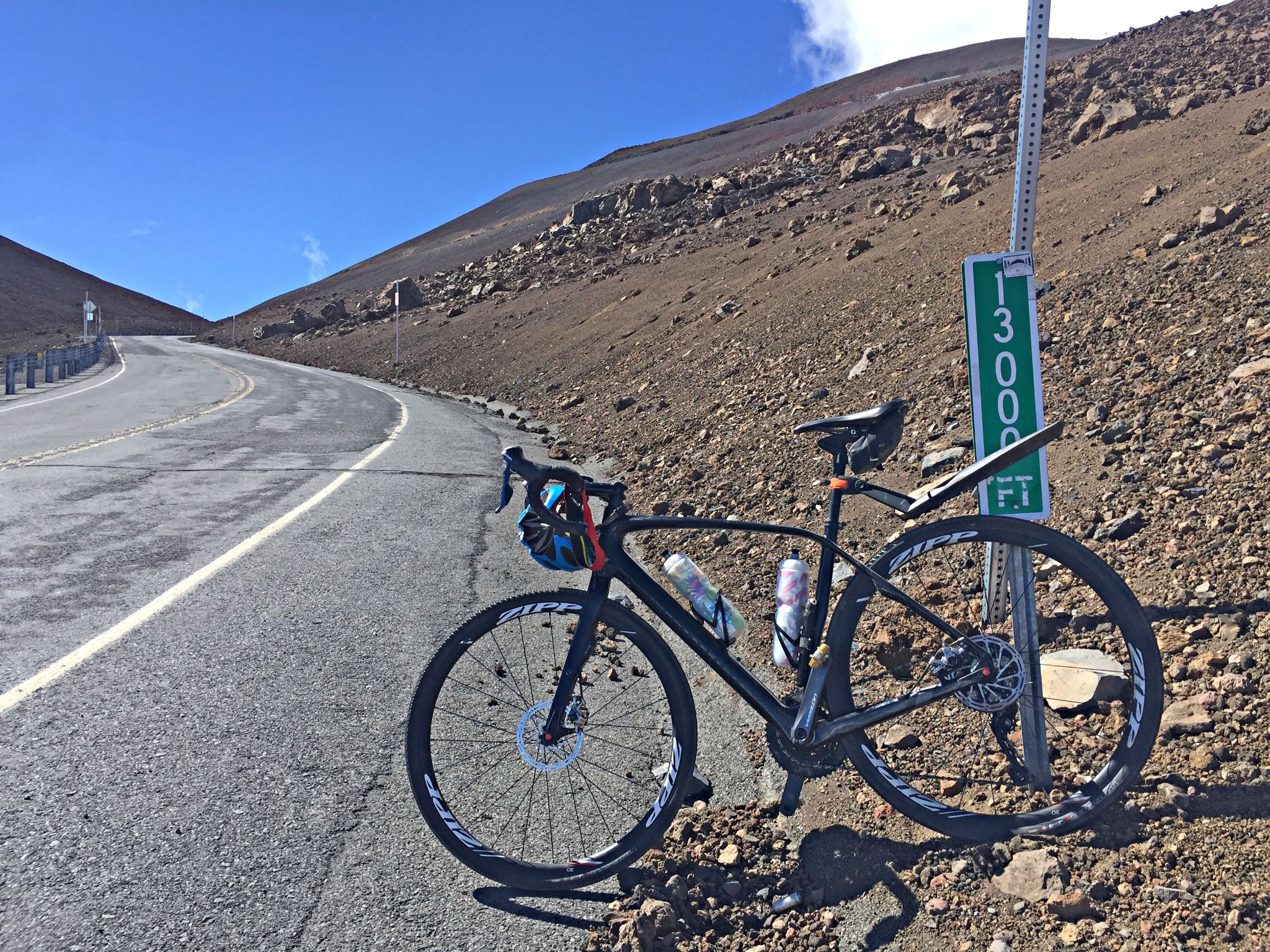 bike parked next to a 13,000 foot elevation sign