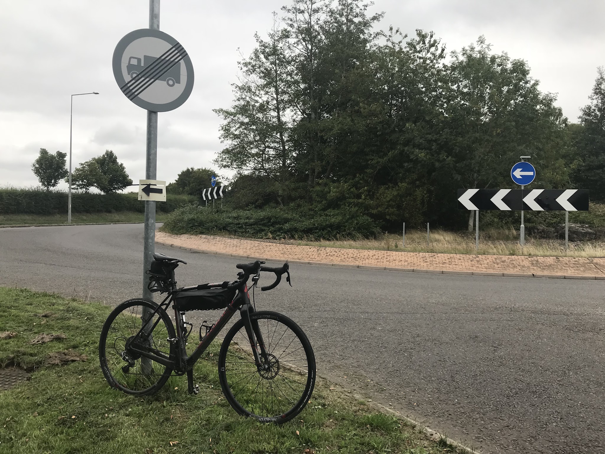 Bicycle ride Jiggers Bank #38 Simon Warren 100 Greatest Cycling Climbs, Britain bike leaning against street sign at roundabout 