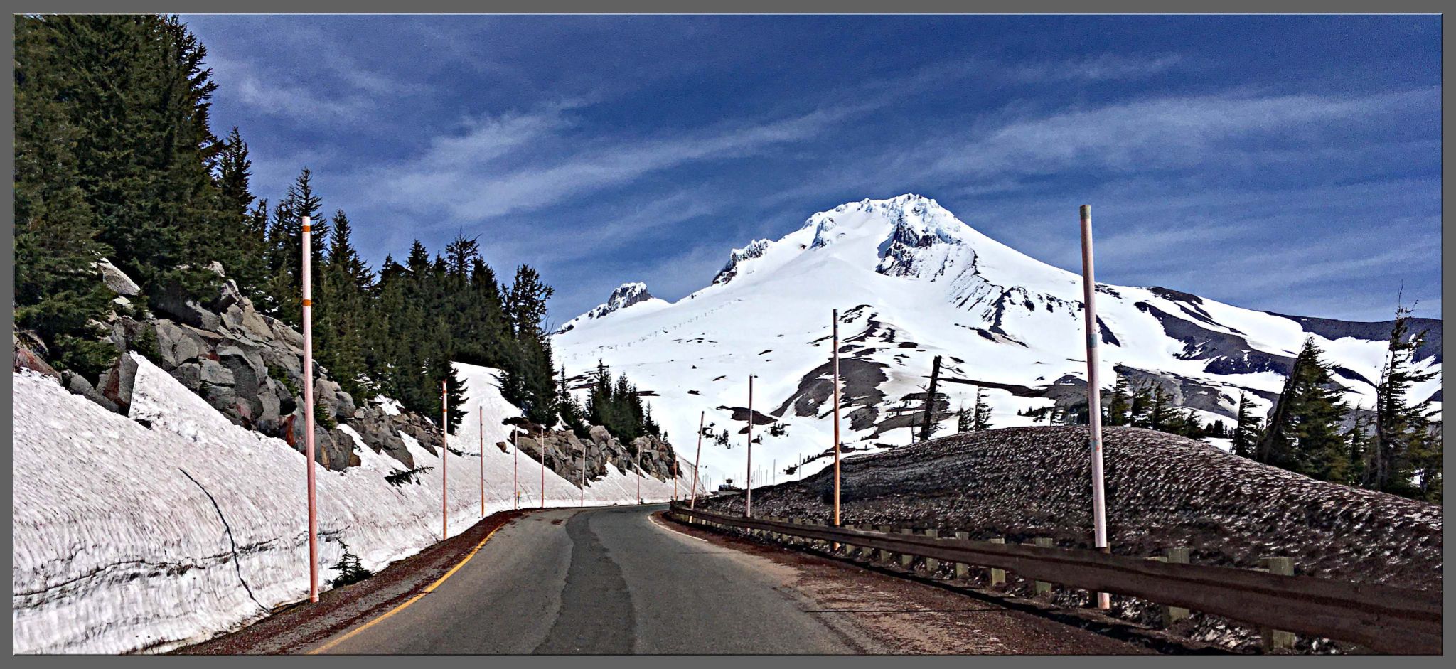 road surrounded by snow, Mount Hood in distance, Oregon Top Bike Climb