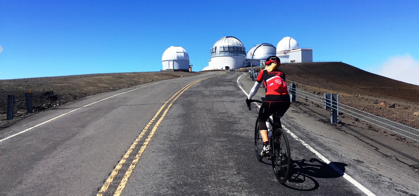 US Most Epic Bike ClimbsRiding bike at the top of Mauna Kea towards observatories