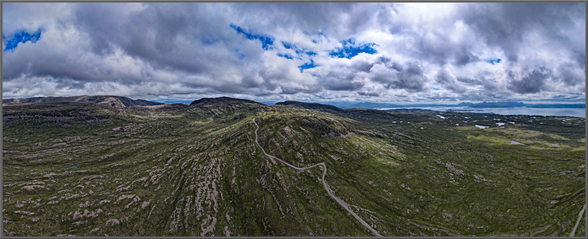 Cycling Bealach na Bà from Applecross, Scotland panoramic view of Bealach na Bà from Applecross climb, road cuts through center of mountains