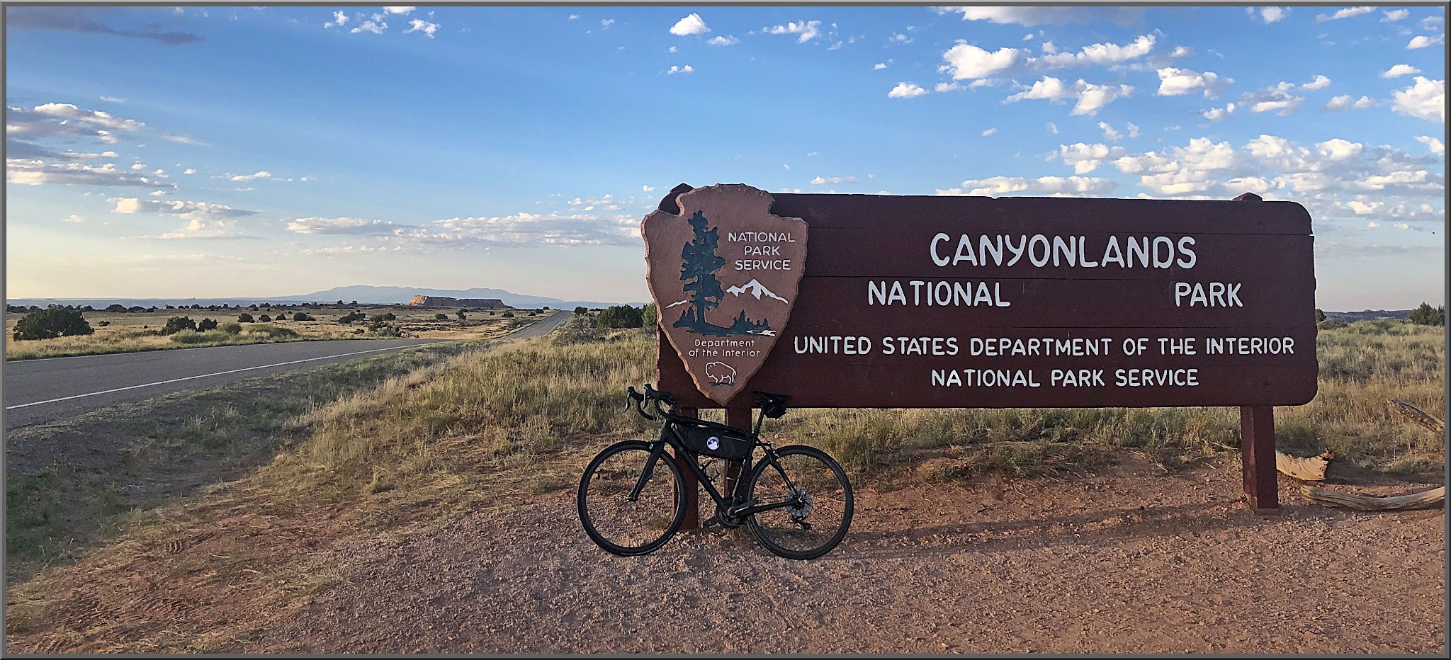 Cycling Canyonlands National Park Cycling Canyonlands National Park - bike parked in front of NPS sign for Canyonlands National Park