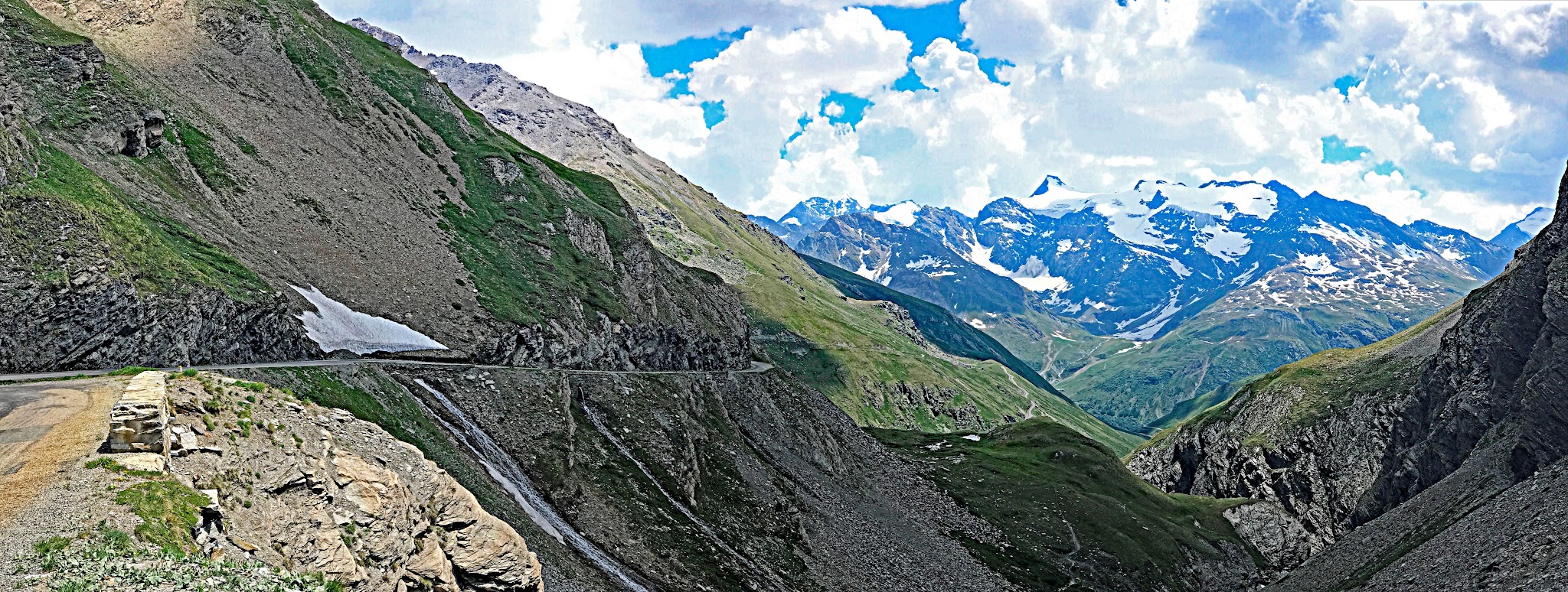 Climbing Col de L’Iseran from Bonneval-sur-Arc by bike; narrow road and cliff