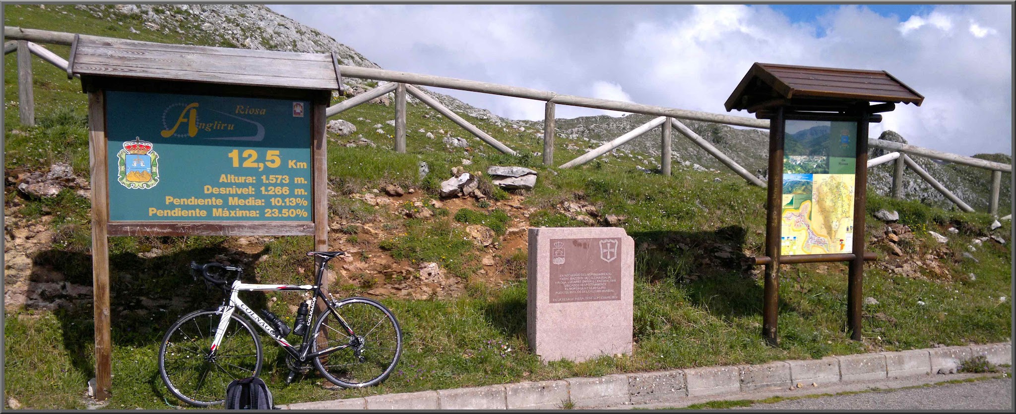 Cycling Alto de l'Angliru, Spain - view from Mirador about 1 kilometer from ride finish, bike parked next to informational signs on hillside