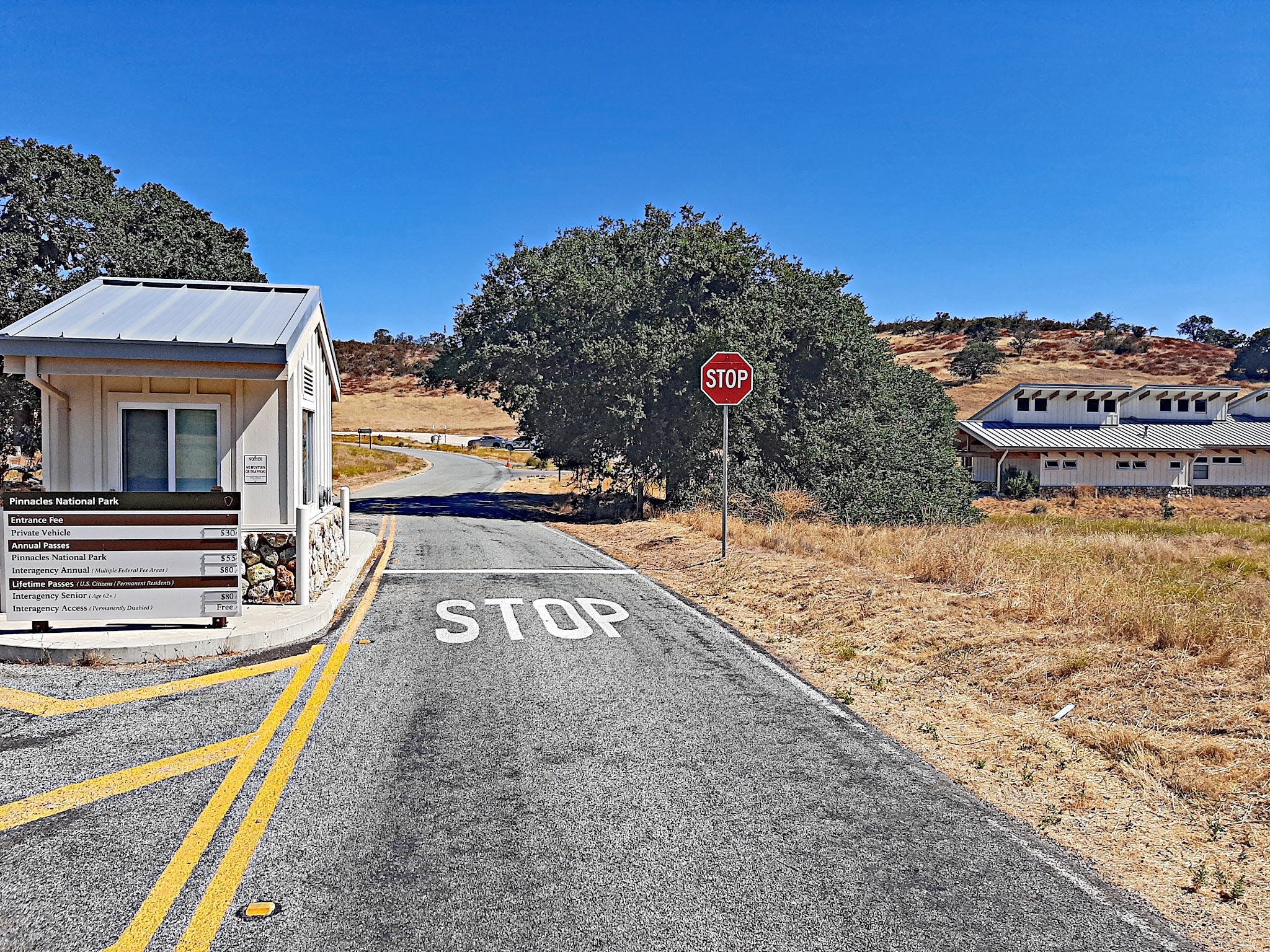 Cycling Pinnacles National Park, California - one-lane road and stop sign at toll booth entering the park