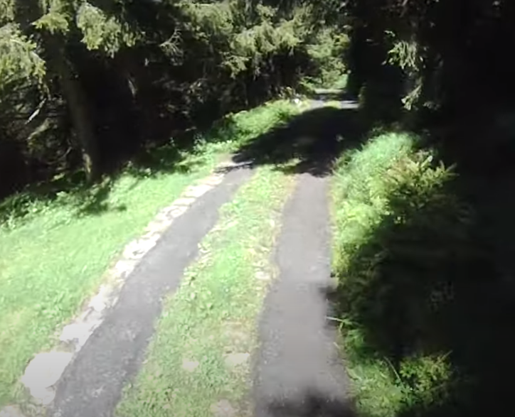 Cycling Pozza San Glisente, Italy - view of roadway surrounded by grass, grass down center of roadway