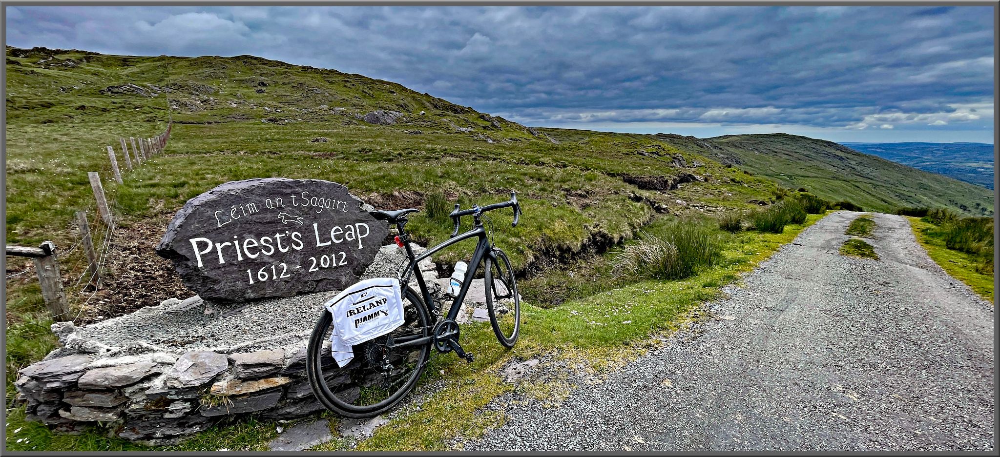bike parked against stone monument reading "Priest's Leap 1612 - 2012"