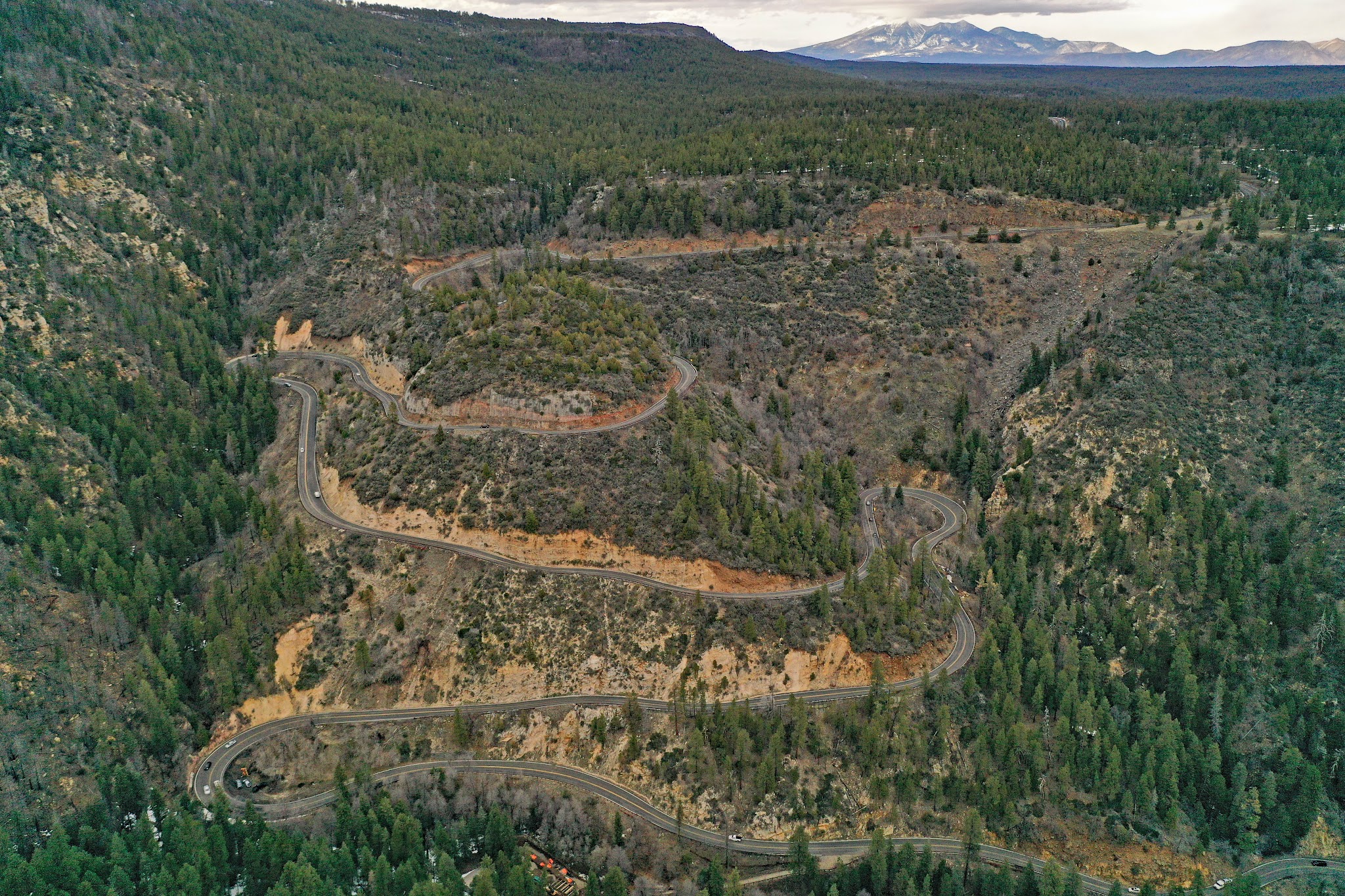 Cycling Sedona and Hwy 89A - hairpins near Oak Creek Scenic Viewpoint - aerial drone photo - mountains near flagstaff in background