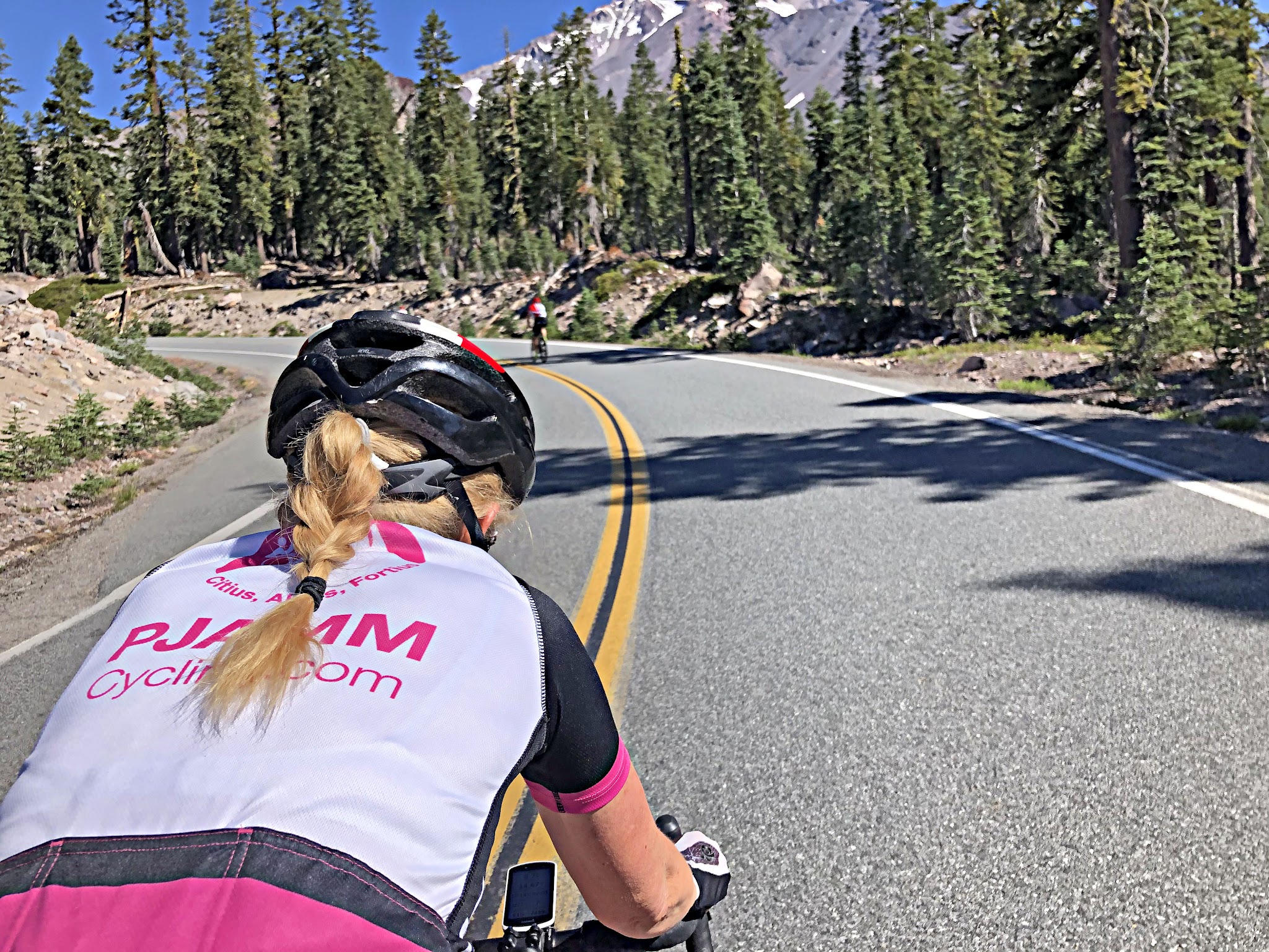 PJAMM Cyclist rides on two-lane alpine roadway