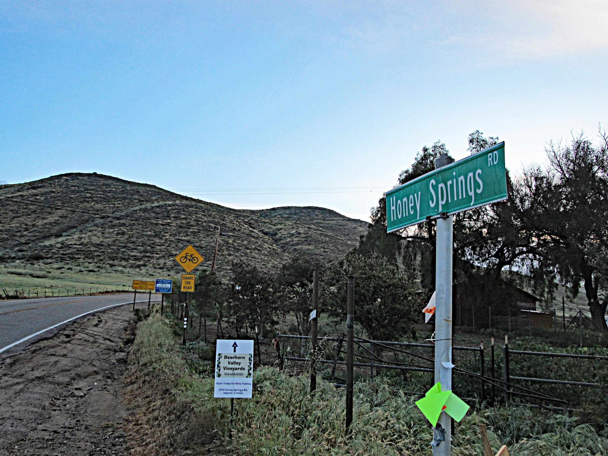 Climbing Honey Springs Road by bike - start of climb and roadway and share the road signs