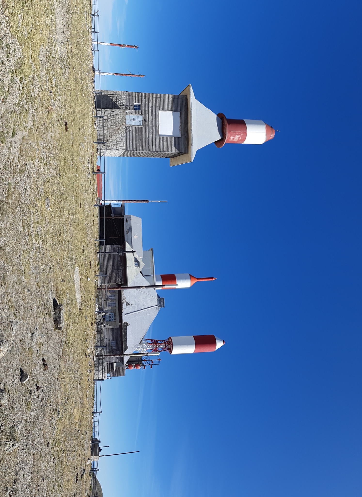 Cycling Bola del Mundo vía Puerto Navacerrada, Spain - giant antennas at climb summit, look like red and white rockets