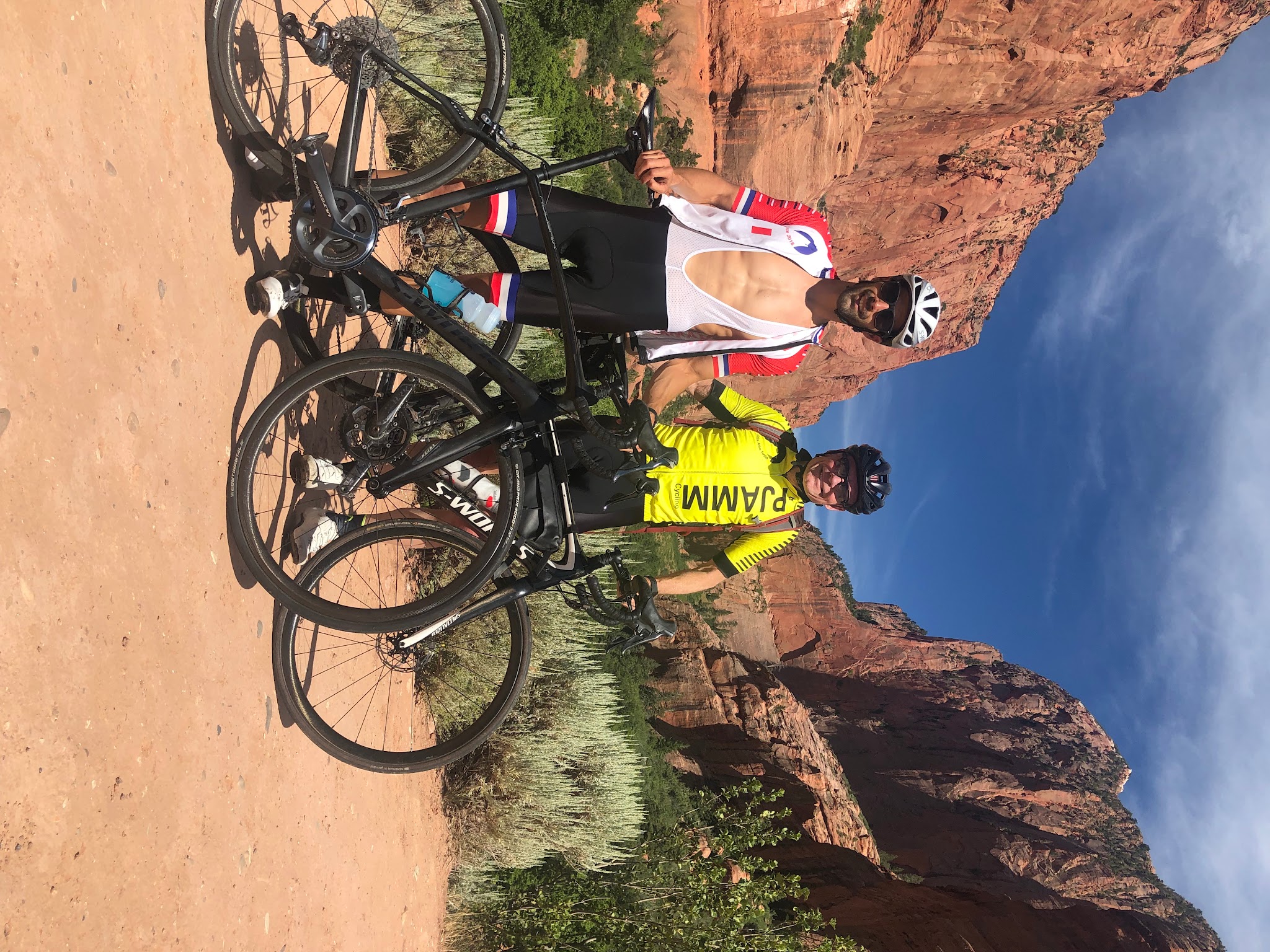 Climbing Kolob Canyon Road by bike - Tayler Hockett and John Johnson with bikes and red rock formations in background