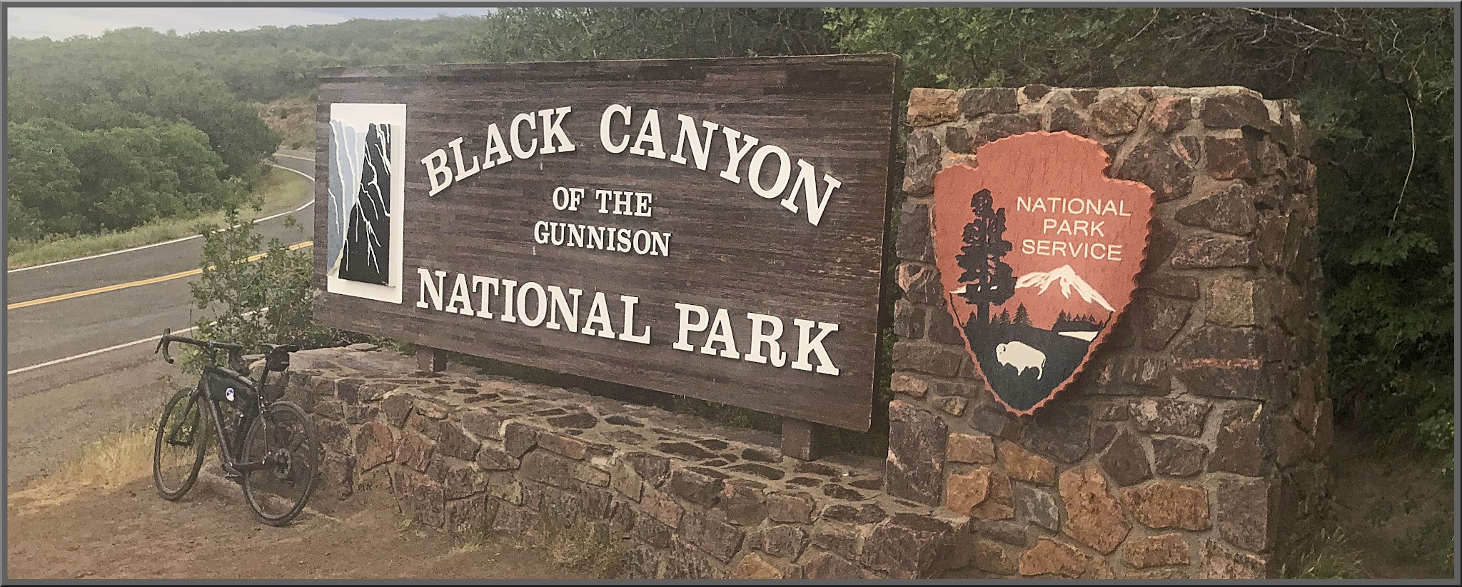 Cycling East Portal, Black Canyon of the Gunnison National Park Cycling East Portal, Black Canyon of the Gunnison National Park - bike parked in front of sign for Black Canyon of the Gunnison National Park