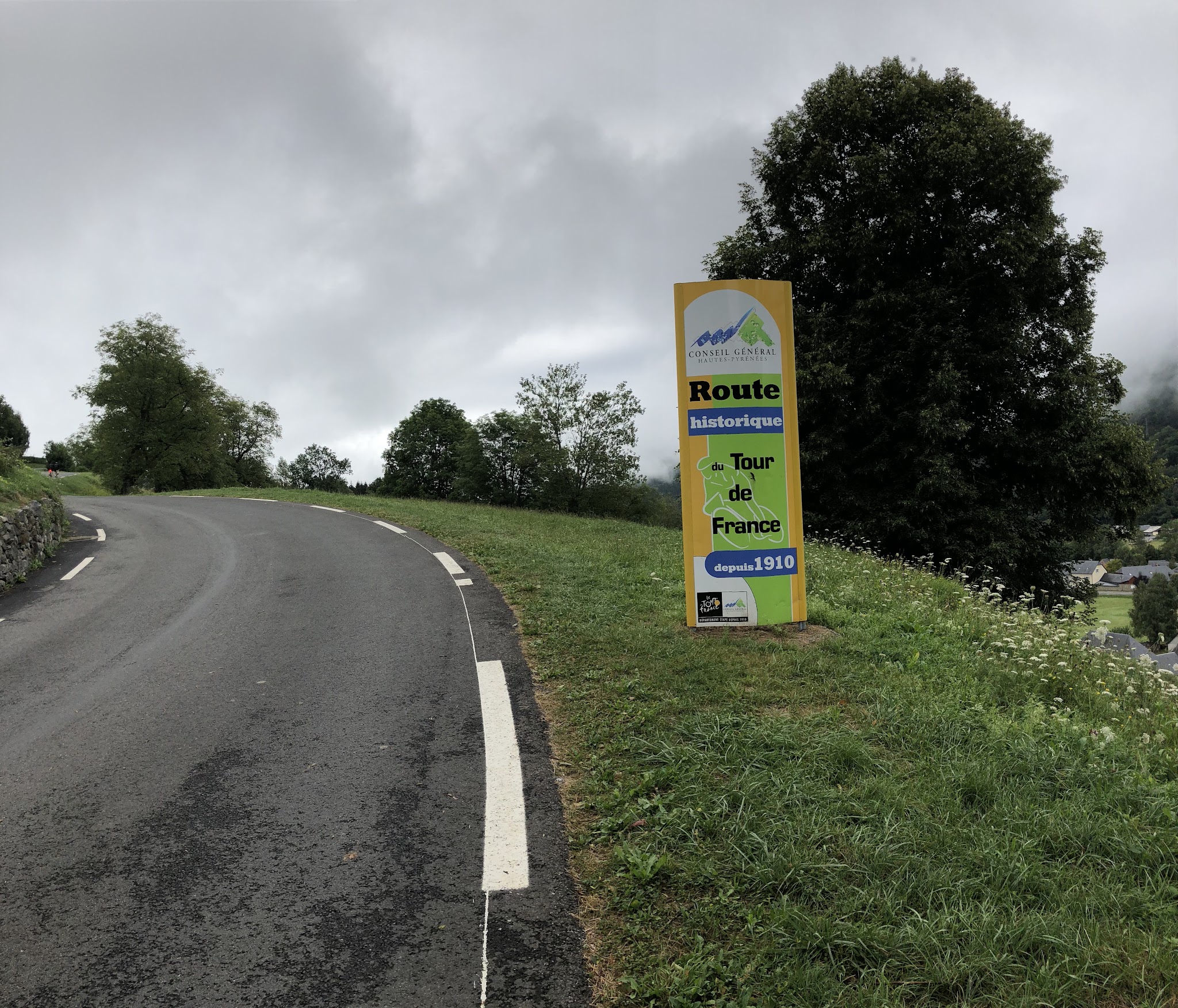 Climbing Col du Soulor from Arrens by bike,  roadway and Tour de France sign.