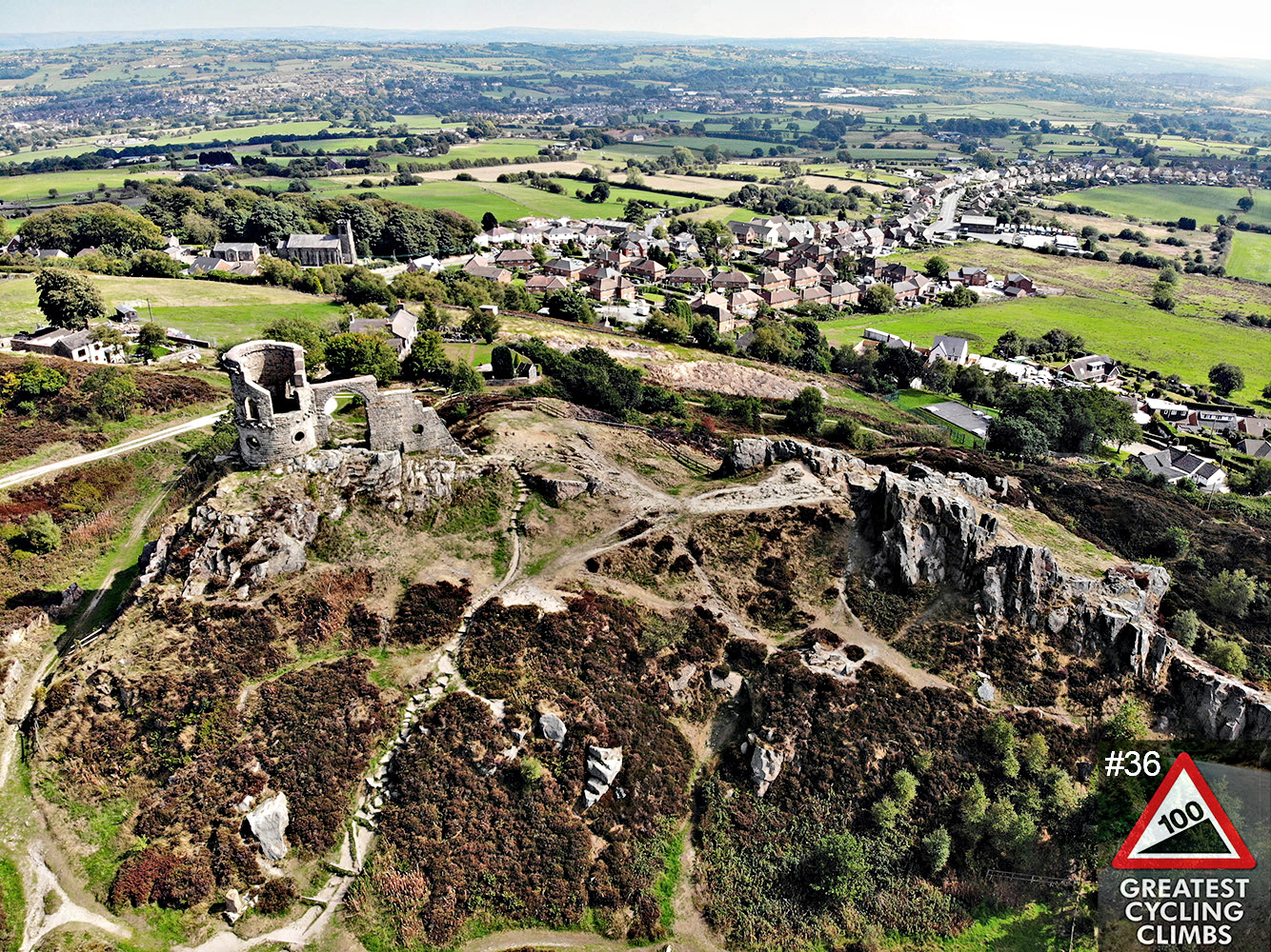 Cycling Mow Cop - aerial view of Mow Cop Castle, Simon Warren's 100 Greatest Cycling Climbs #36 logo in corner