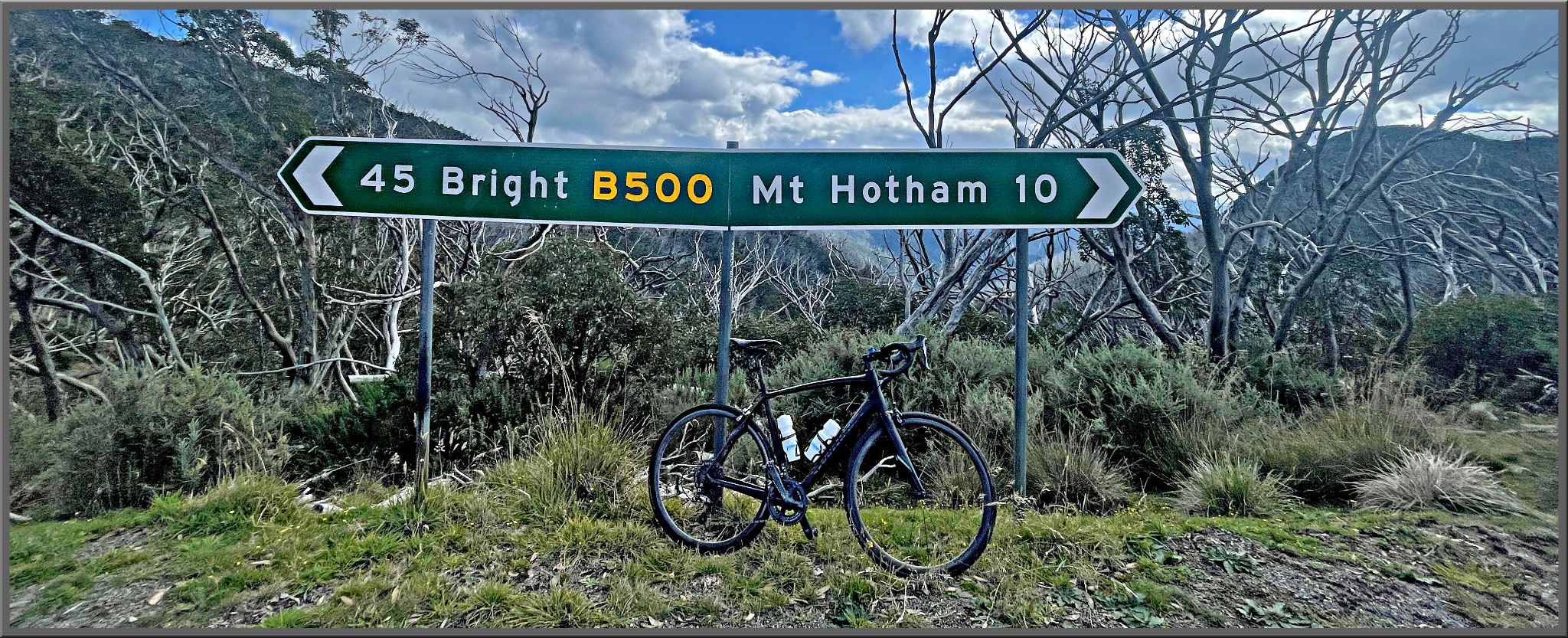 bike parked in front of road sign for Bright and Mt. Hotham