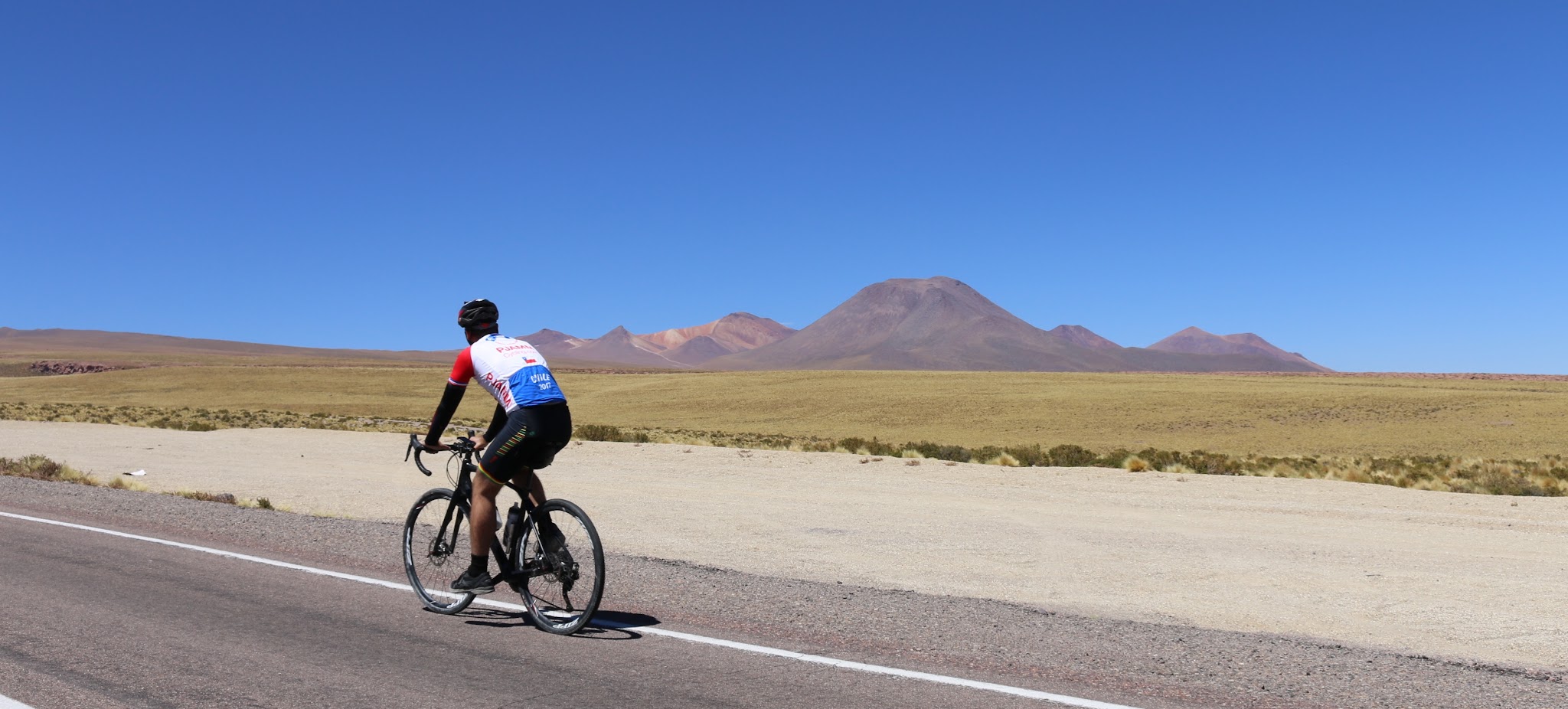Hwy 27, Atacama, Chile Cycling Hwy 27, Atacama, Chile - cyclist riding on road