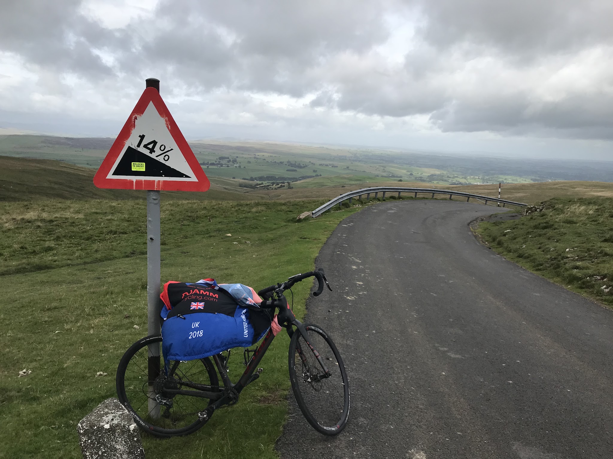 Bicycle ride Lamps Moss #78 Simon Warren 100 Greatest Cycling Climbs  - bike leaning against 14% steep grade sign, road, field