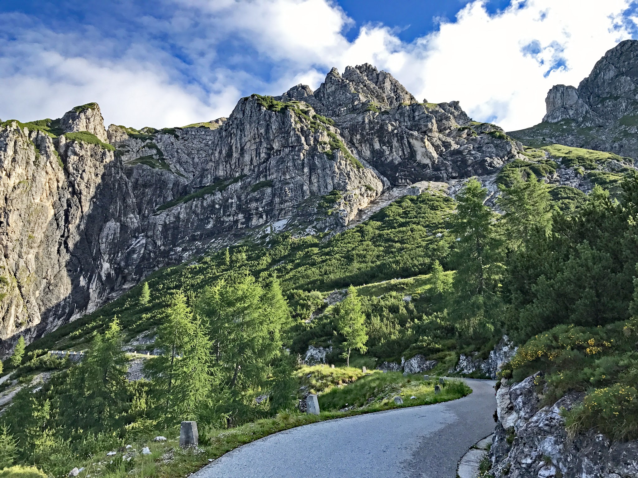 Climbing by bike Vzpon na Mangart - roadway, steep moss covered mountains