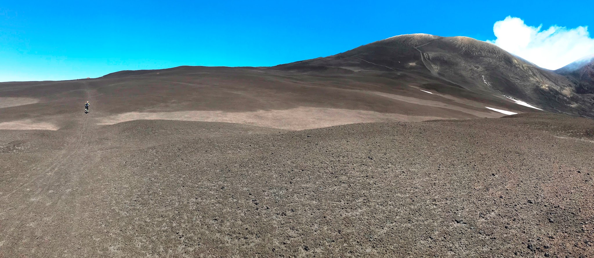 Cyclist riding mountain bike on Mount Etna Volcano Sicily Italy