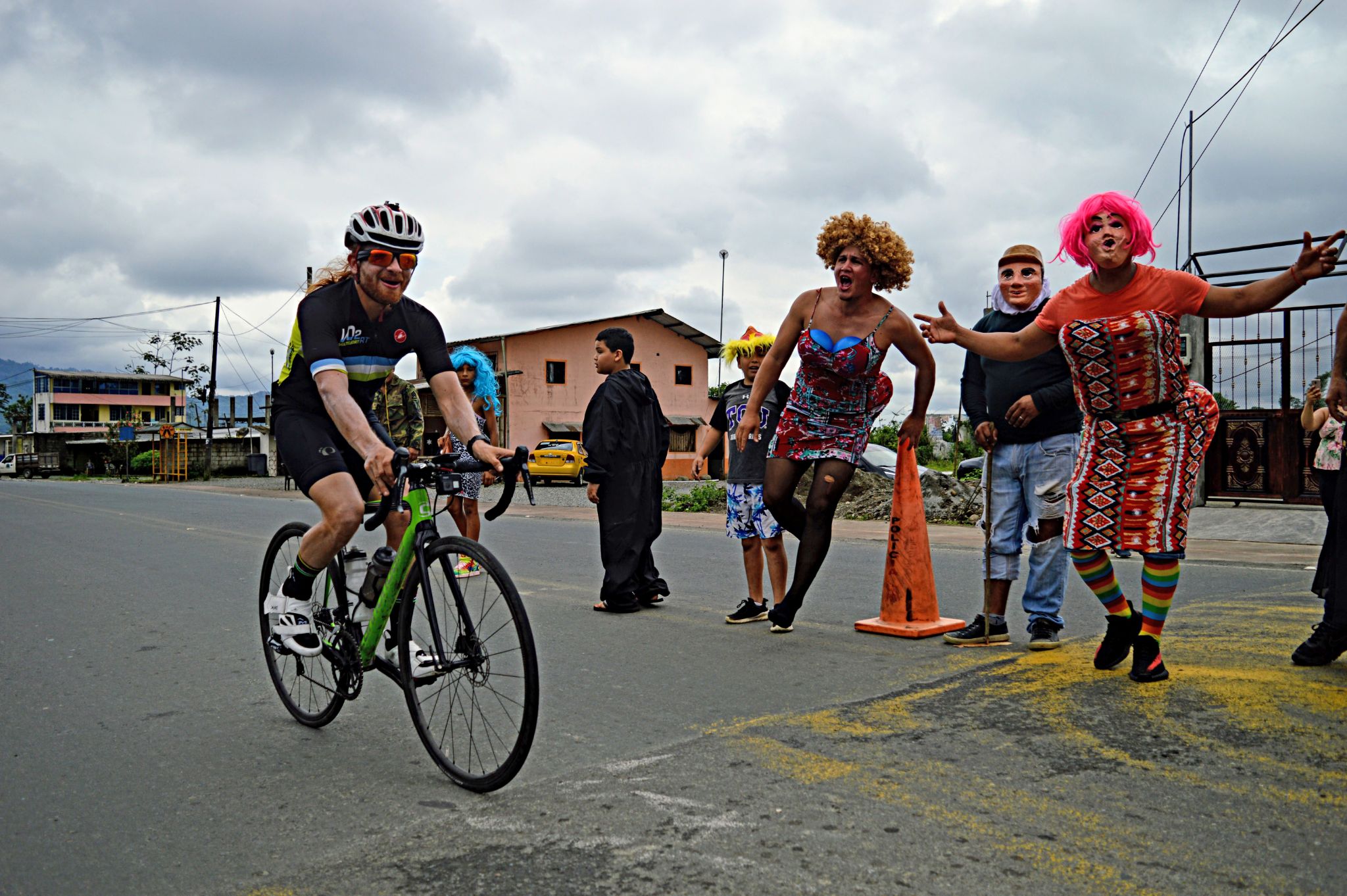 Cycling Apagua, Ecuador  - PJAMM Cyclist rides past "Las Viudas", Ecuadorian New Year's Tradition