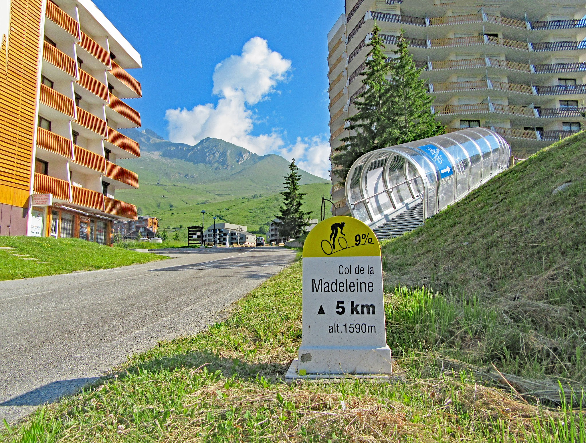 Bicycle ride of Col de Madeleine from La Chambre  - ski resort Longchamp with road, mountain and kilometer marker
