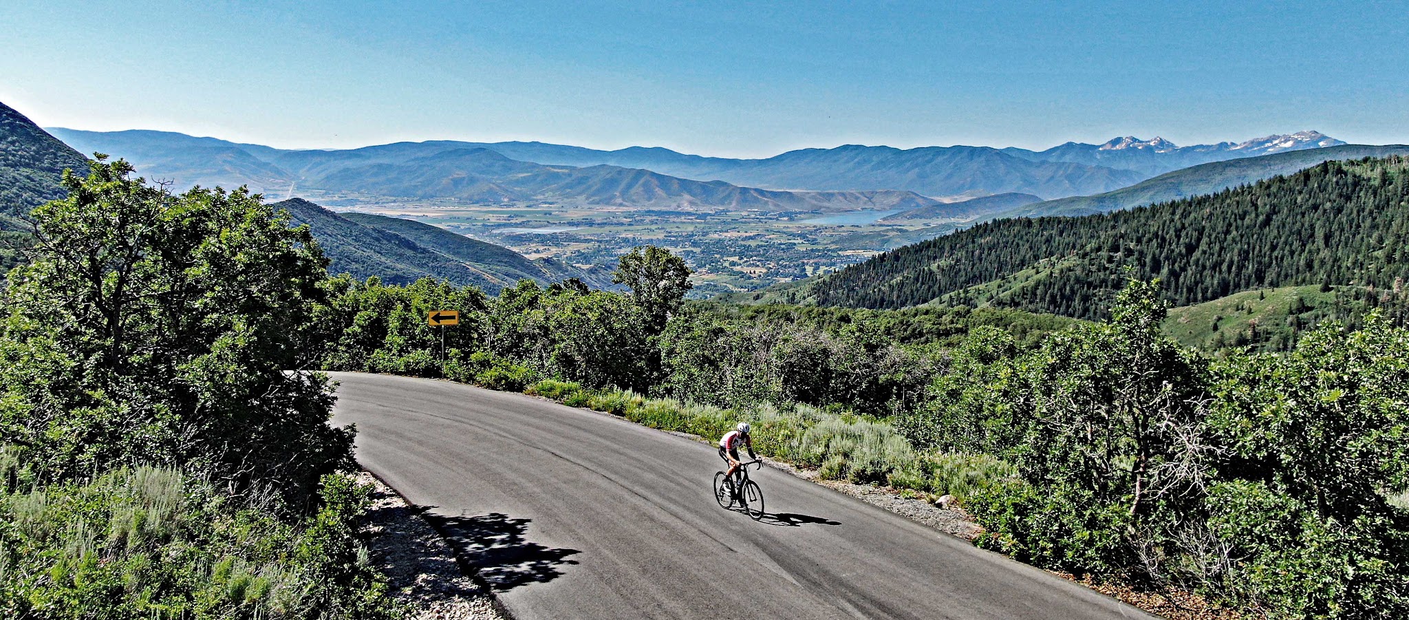 cycling Empire Pass from Midway - cyclist on bike with deer park reservoir in background