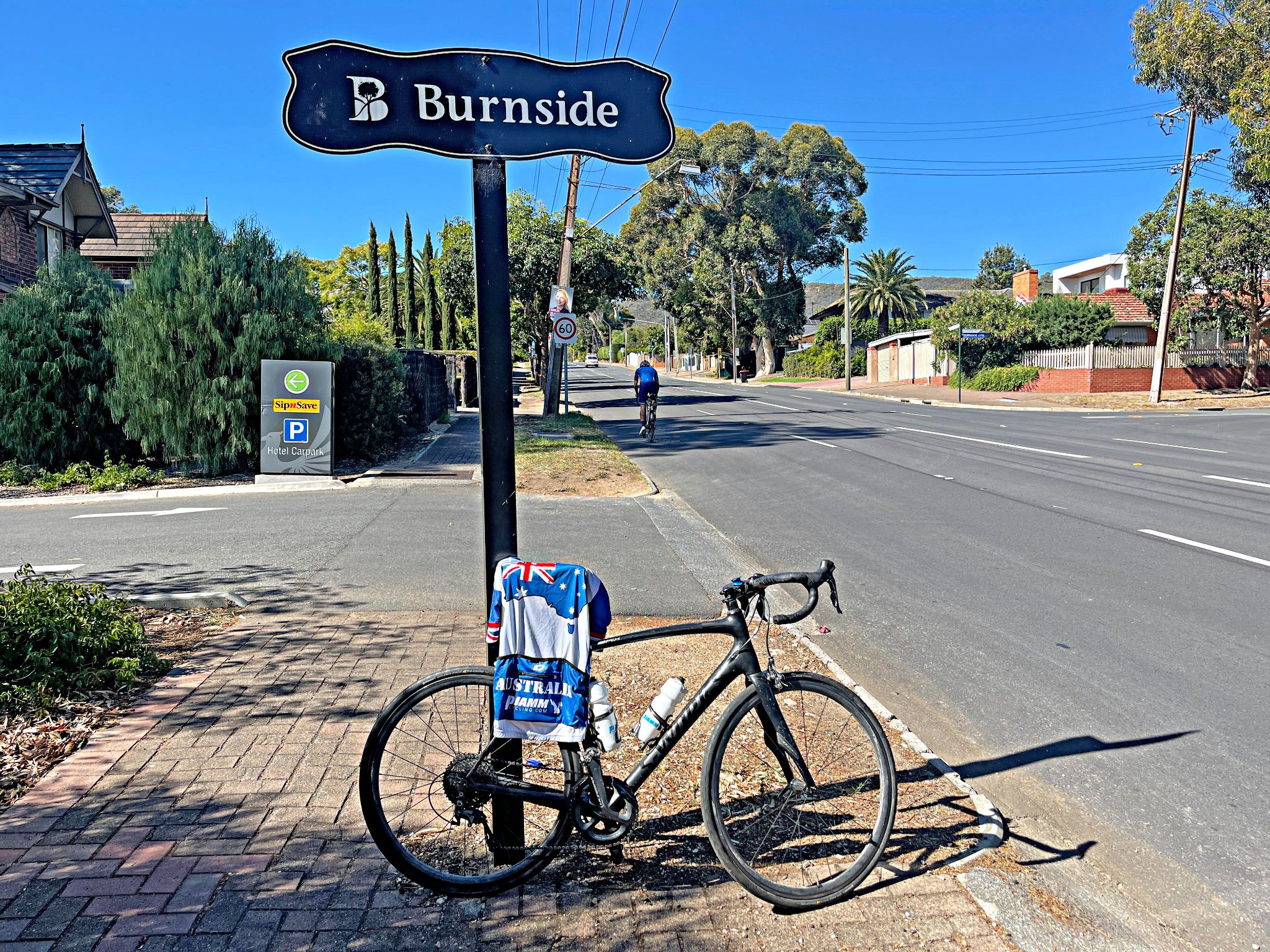 bike and PJAMM Cycling Australia jersey lean against sign for Burnside