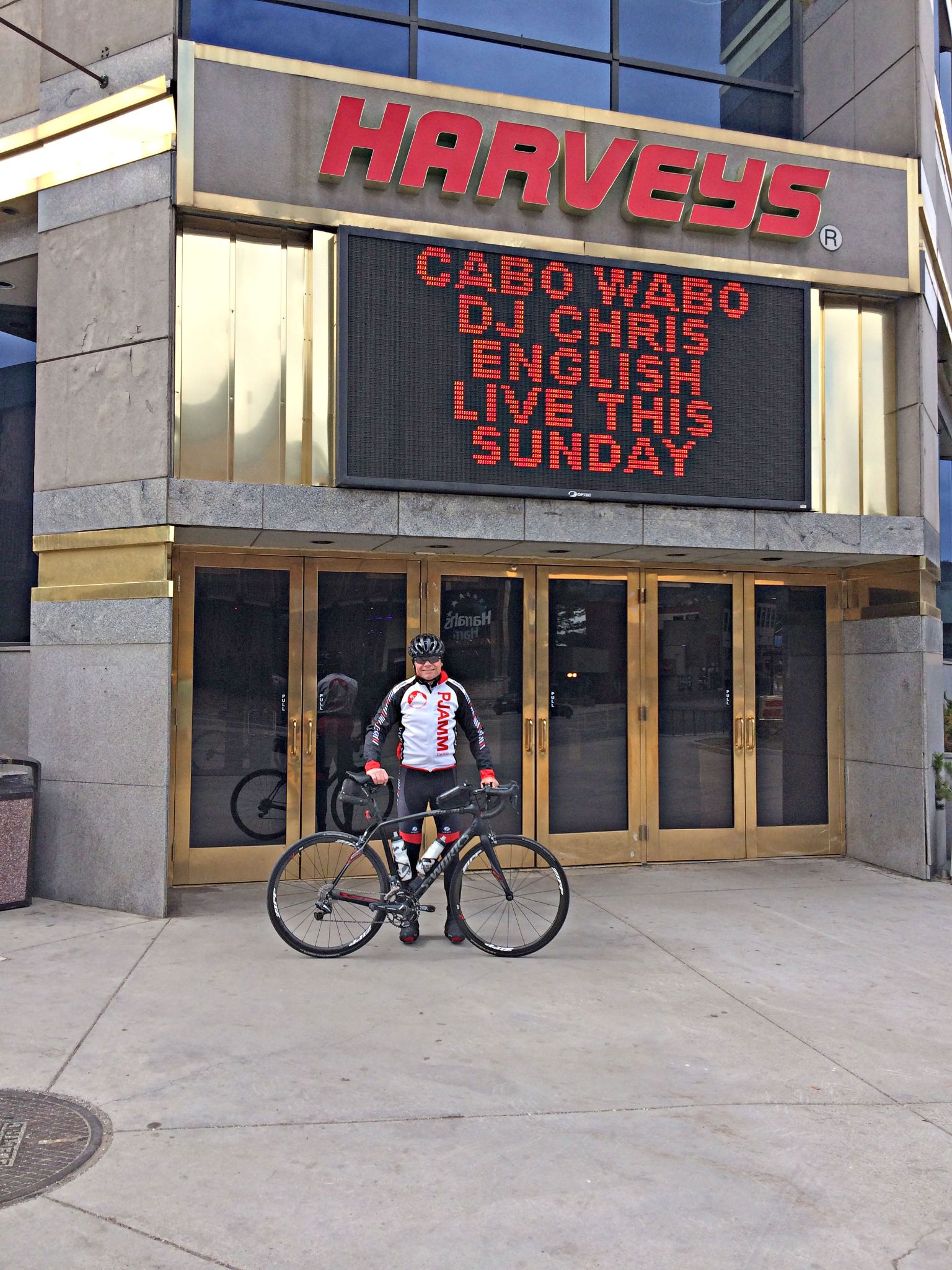 PJAMM Cyclist John Johnson stands with bike in front of Harvey's; crossing the state line into Nevada