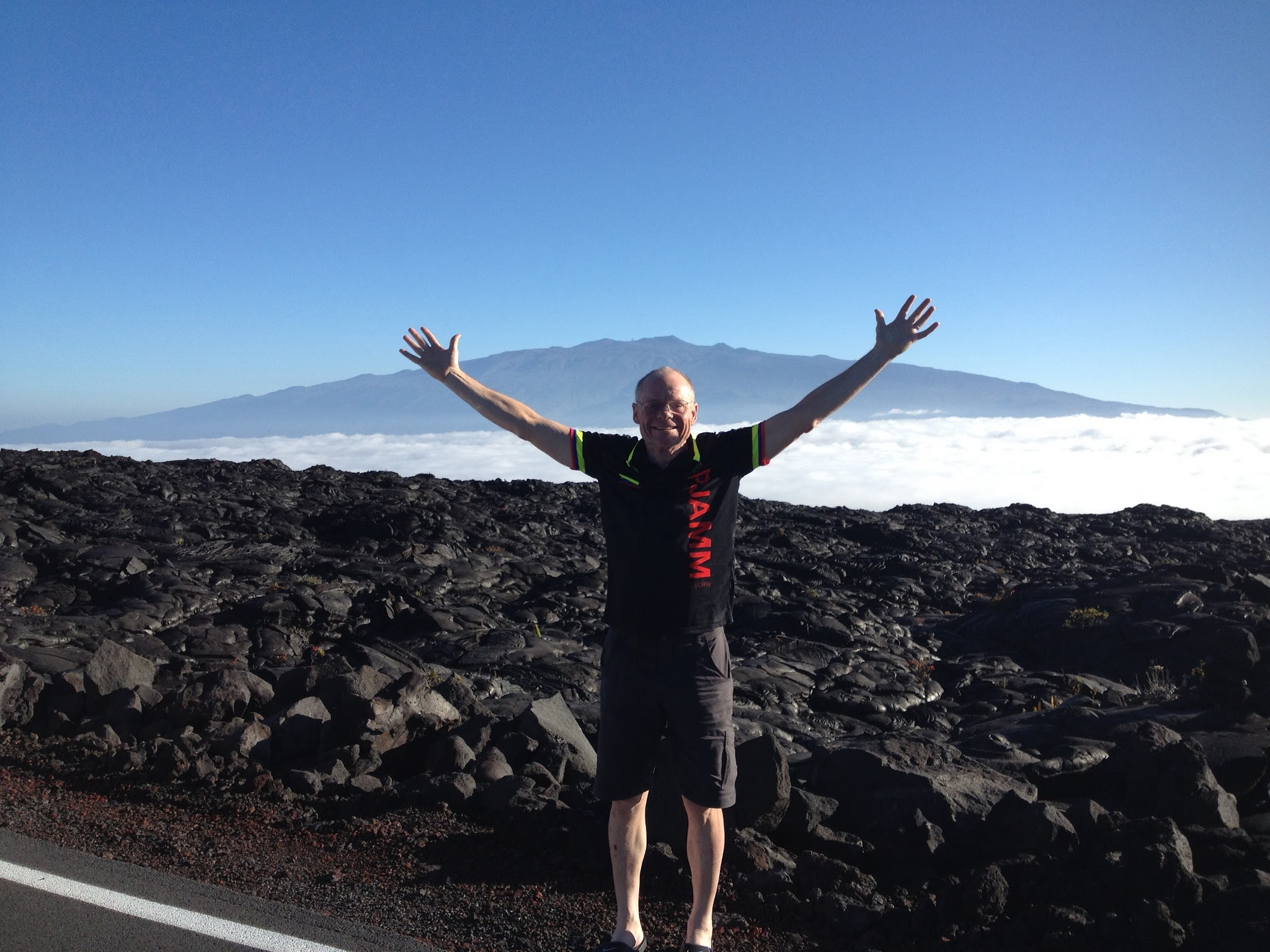 cycling Top 10 US Bike Climbs - Mauna Kea cyclist coming above the clouds
