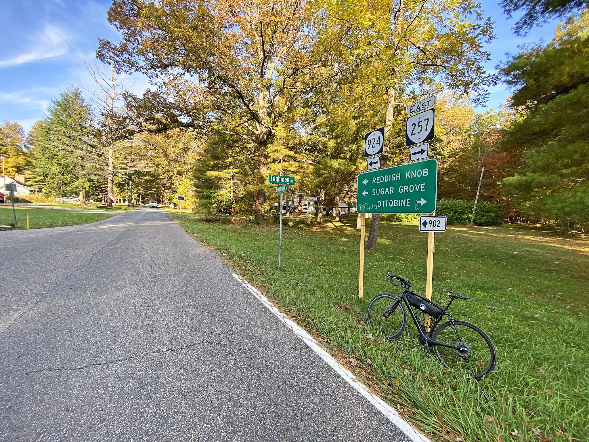 Cycling Reddish Knob, Virginia - bike parked against road sign at climb's start, signs for Reddish Knob, etc.