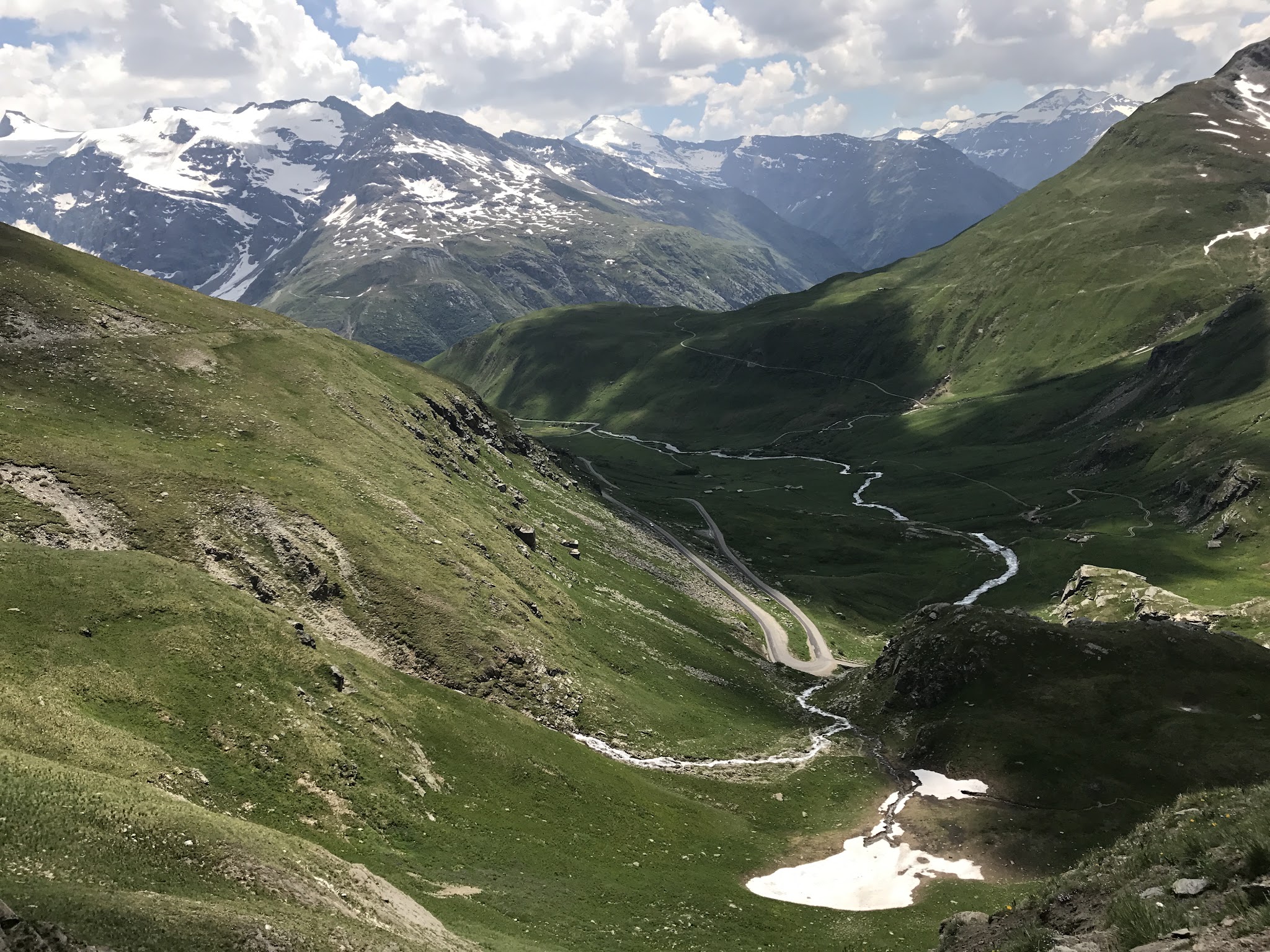 Climbing Col de L’Iseran from Bonneval-sur-Arc view of meadow and road far below