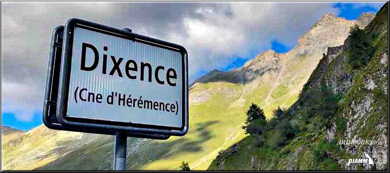 Cycling Barrage de la Grande Dixence, Switzerland Cycling Barrage de la Grande Dixence, Switzerland - road sign reads Dixence (Cne d'Heremence), swiss alps in background