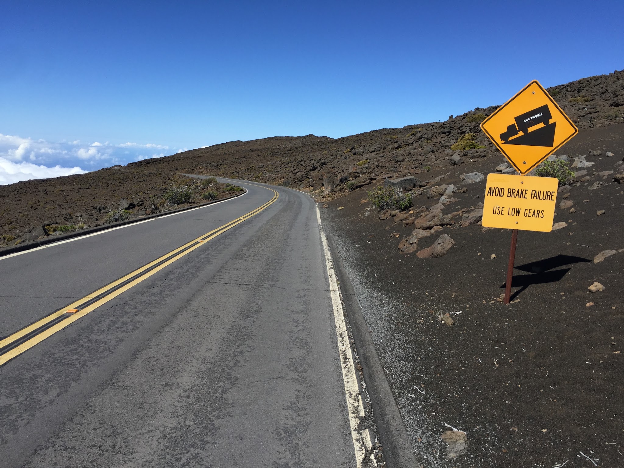 cycling Haleakala Volcano, road, steep grade sign, blue sky