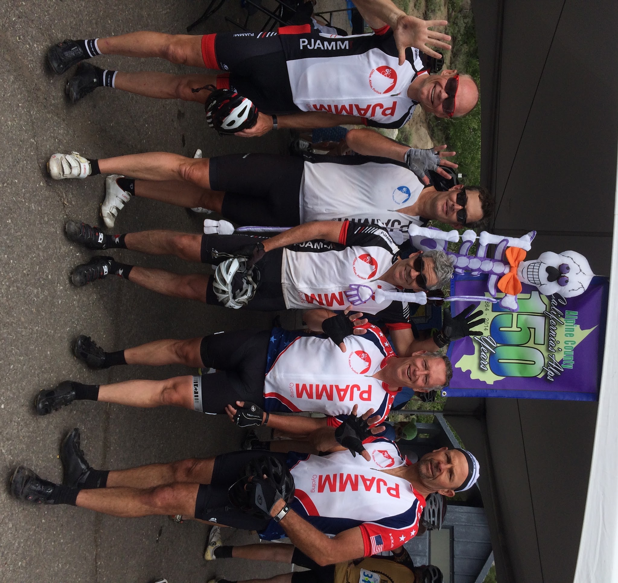 Cycling Monitor Pass East and West - PJAMM cyclists at finish of Death Ride holding up 5 fingers for 5 passes - skeleton 