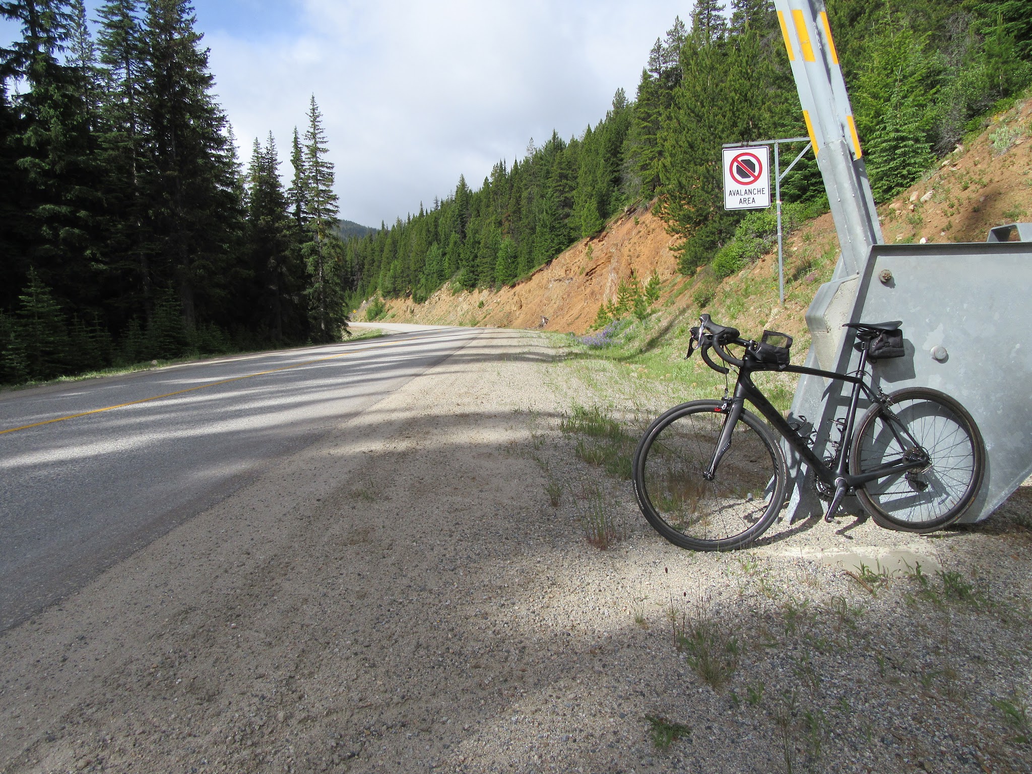 Bicycling Apex from Penticton - bike leaning against gate, road