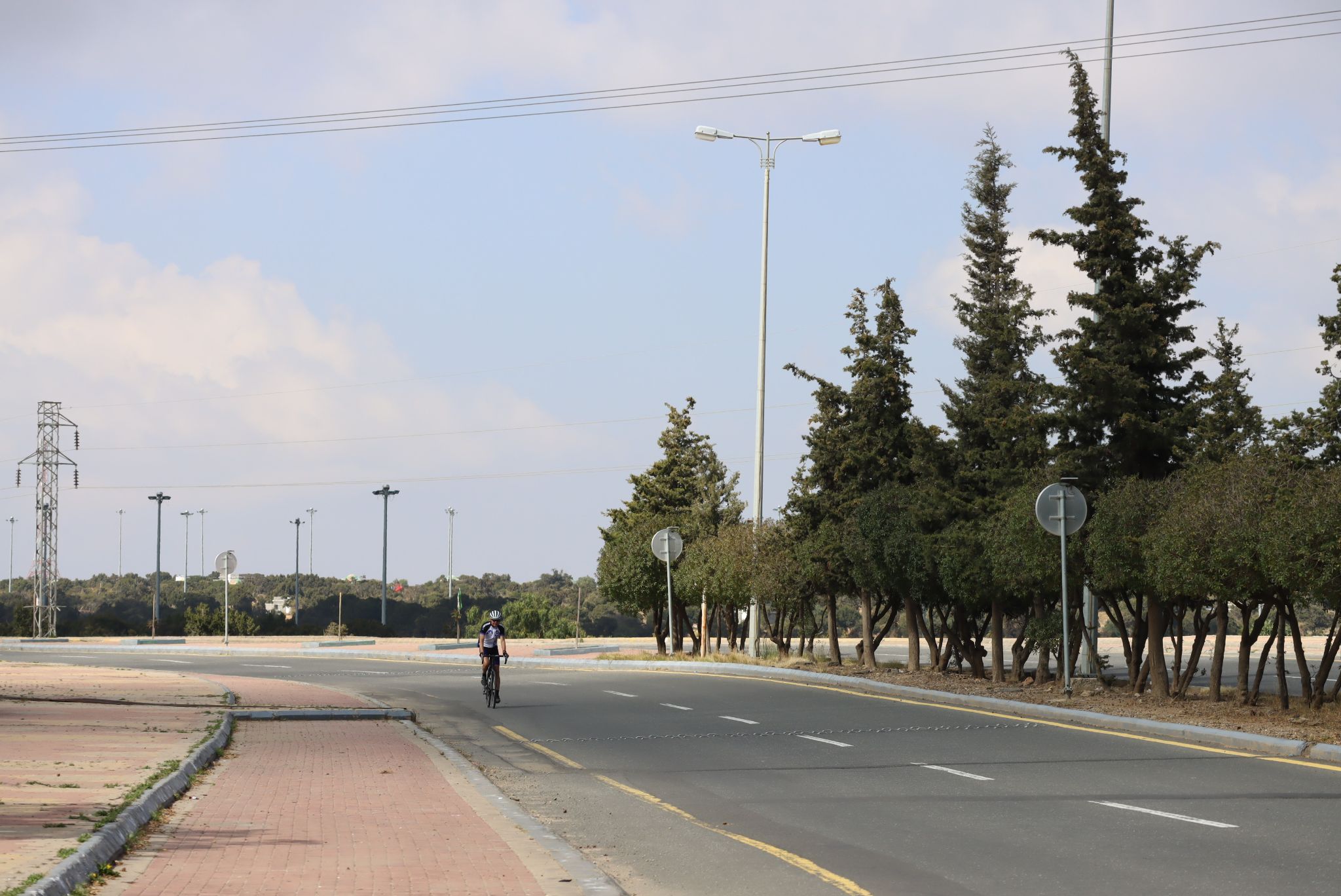 Cycling Mount Souda, Saudi Arabia - John cycling on two lane roadway approaching the finish of the climb