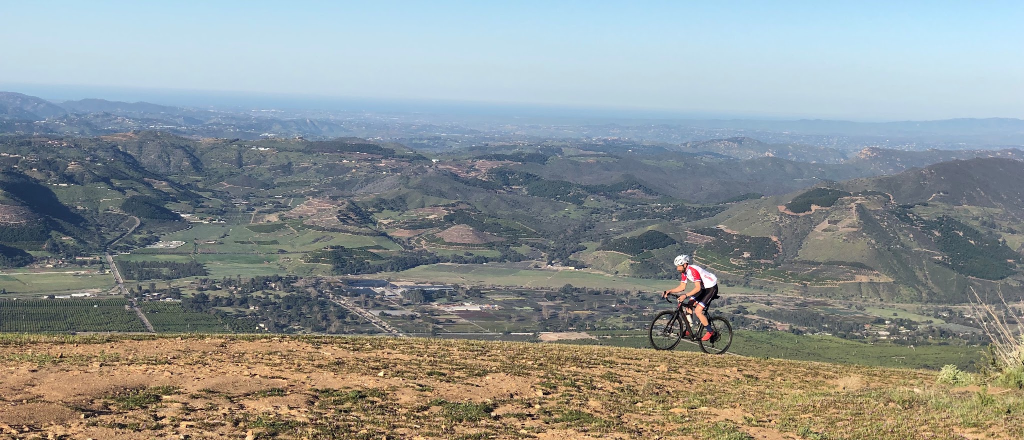 Cycling Southern California - Nate Harrison Grade, panoramic view of cyclist climbing along Nate Harrison Grade, overlooking San Diego County in the distance