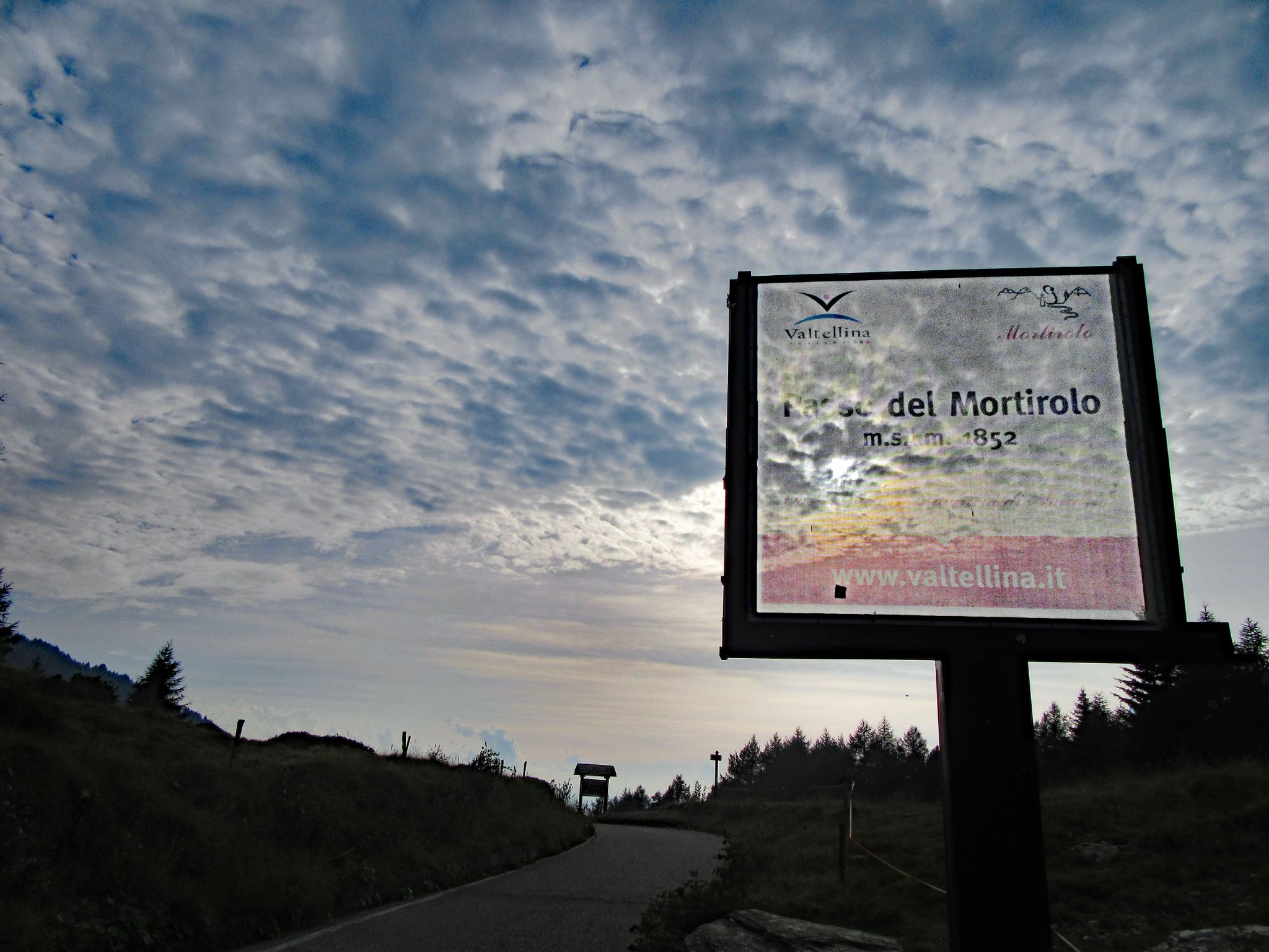 sign for Passo Mortirolo at dusk