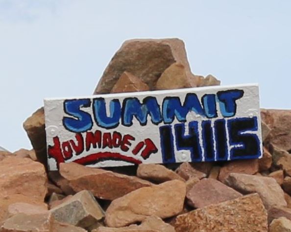 14,115' sign at top of Pikes Peak climb by bike