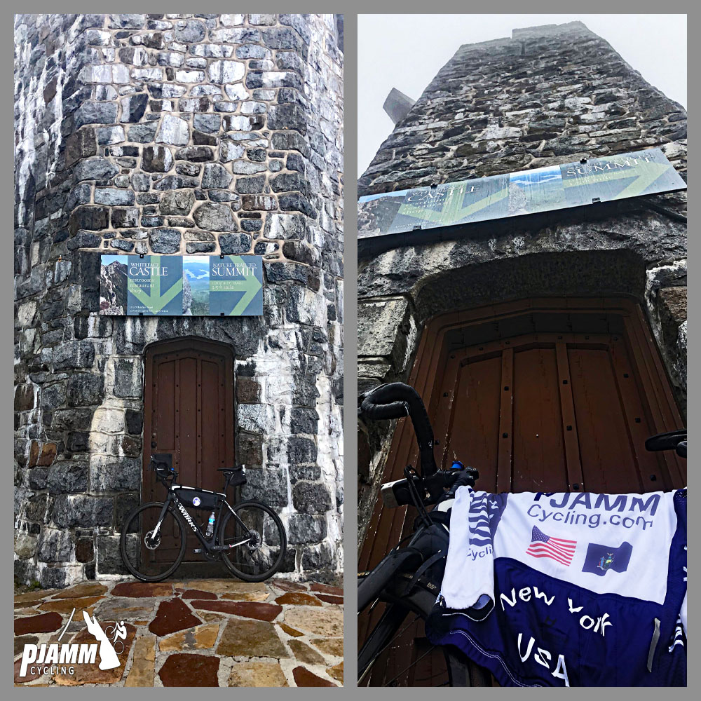 Cycling Whiteface Mountain - entrance to tall stone castle with large dark brown door, road bike leaning against door with PJAMM Cycling jersey draped over it