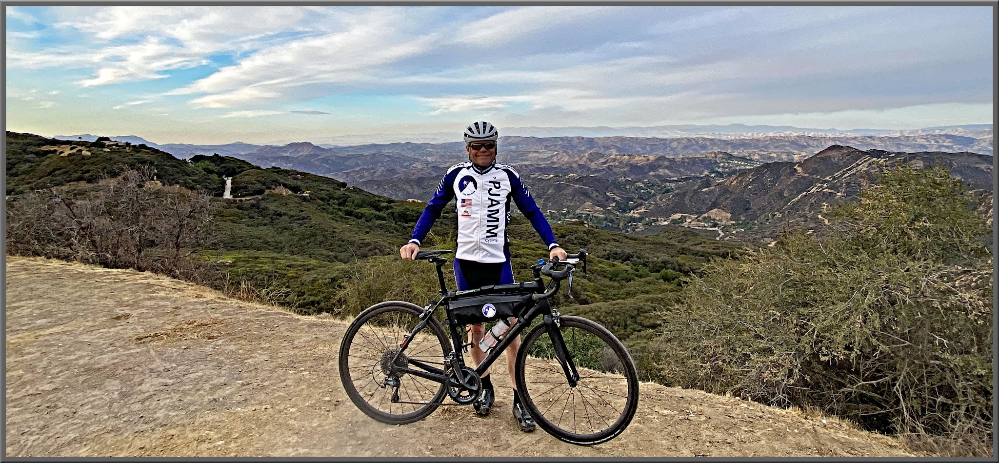 Cycling Topanga Canyon Blvd to Stunt Road - PJAMM Cyclist John Johnson stands with bike at climb summit