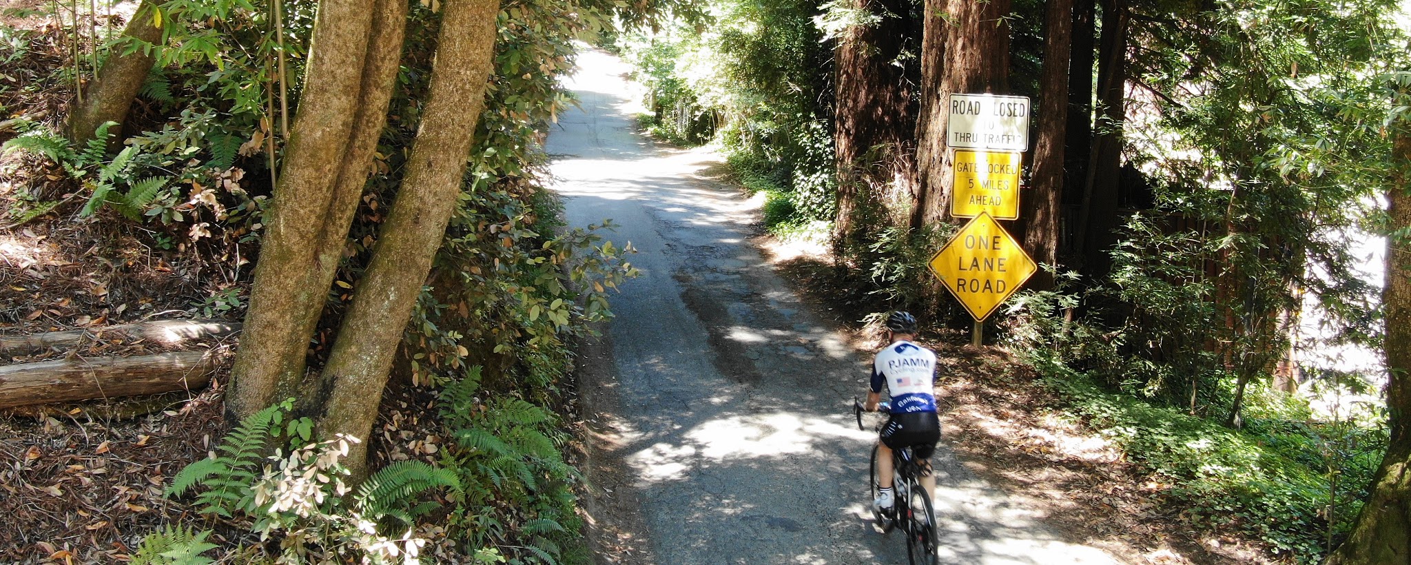 Cycling Old Cazadero Road - cyclist riding past road sign