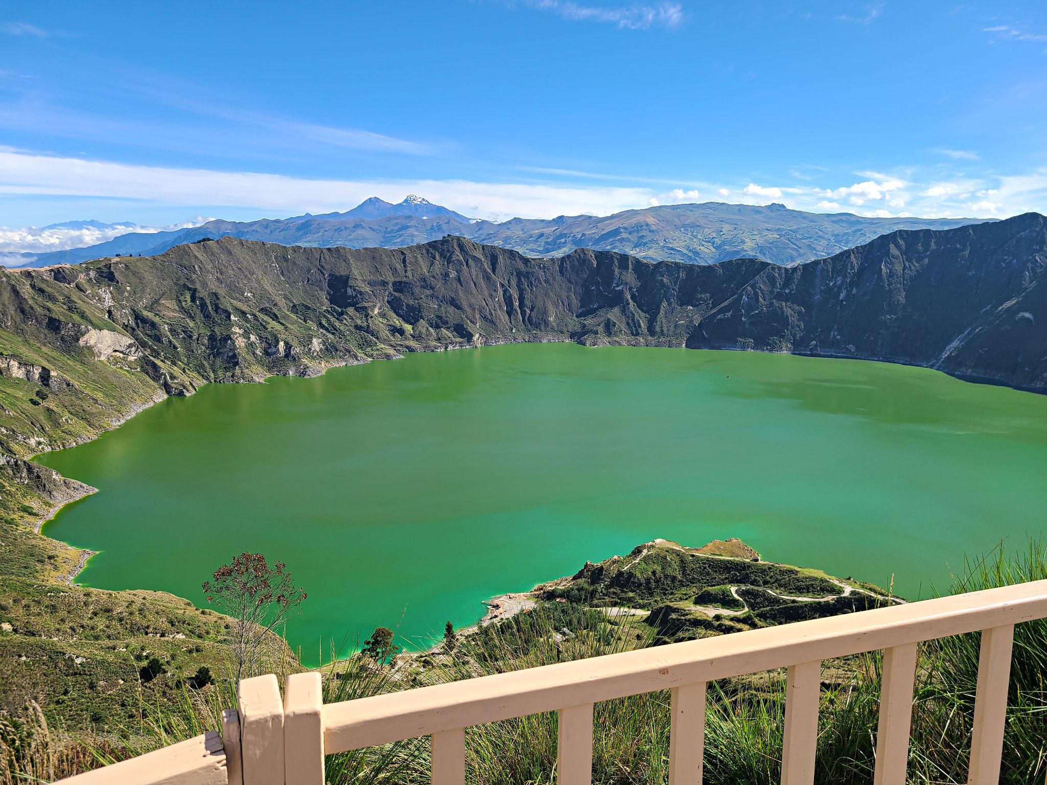 Cycling Apagua, Ecuador  - view looking down over caldera lake, green water of Quilotoa Lagoon