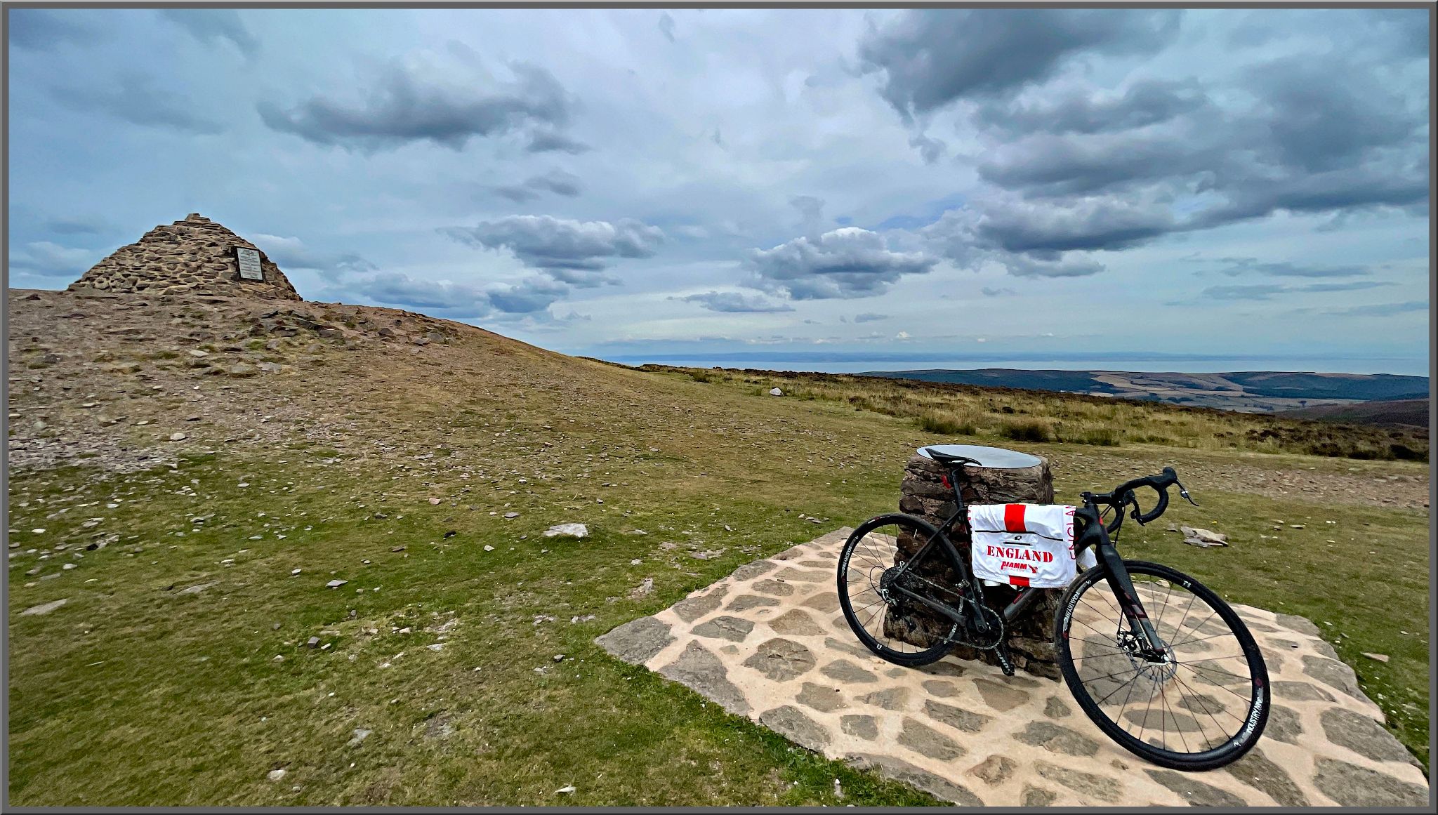 bike parked on stone platform at base of stone monument, Dunkery Hill