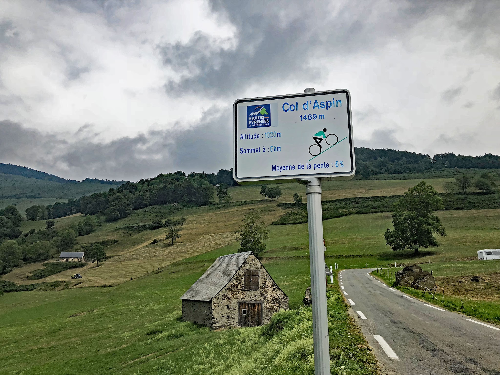 sign at the midway point of climb, Col d'Aspin; scenic pastoral landscape