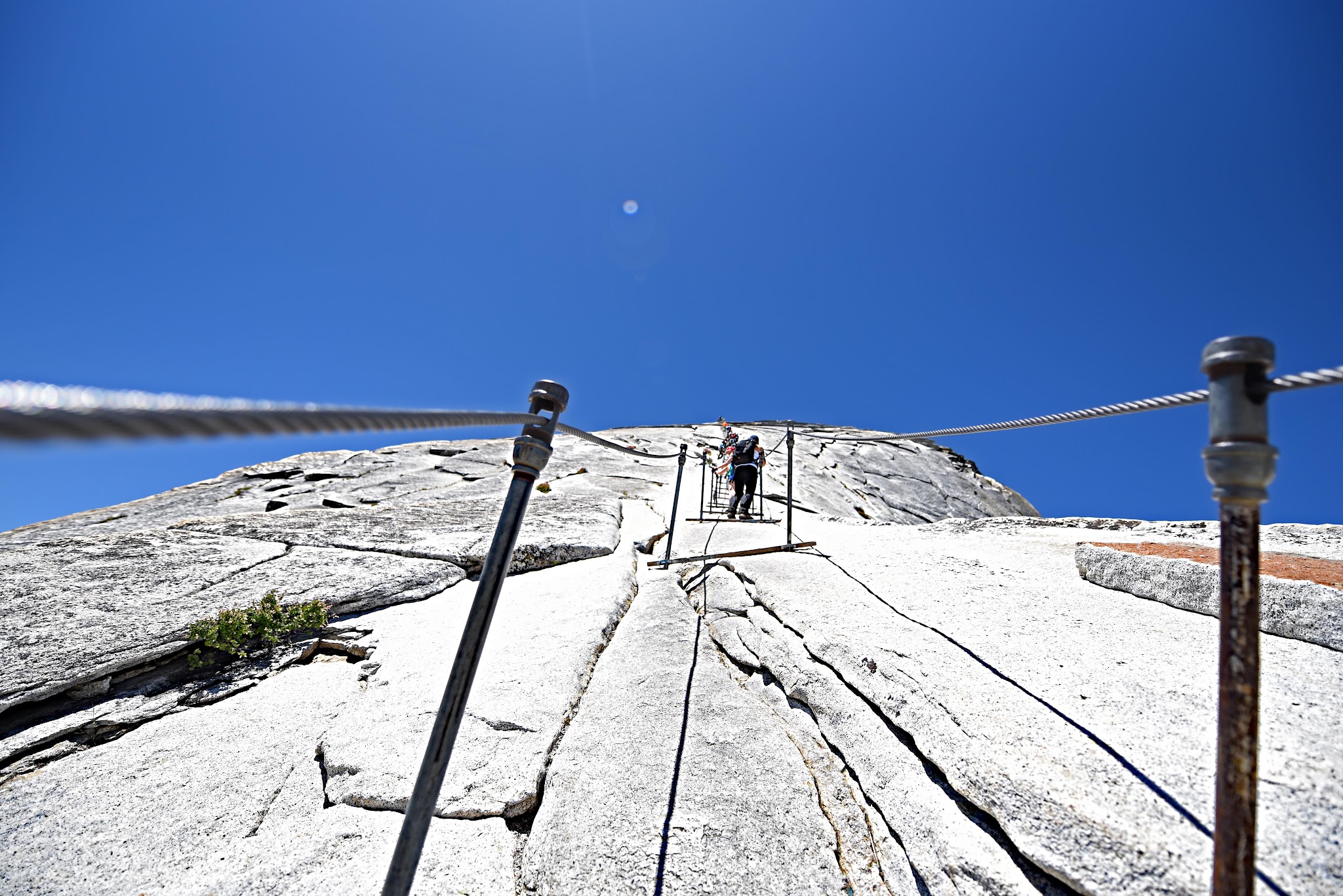Cycling and hiking Yosemite Valley to Glacier Point to Half Dome -bottom of cables at Half Dome - hikers climbing Half Dome