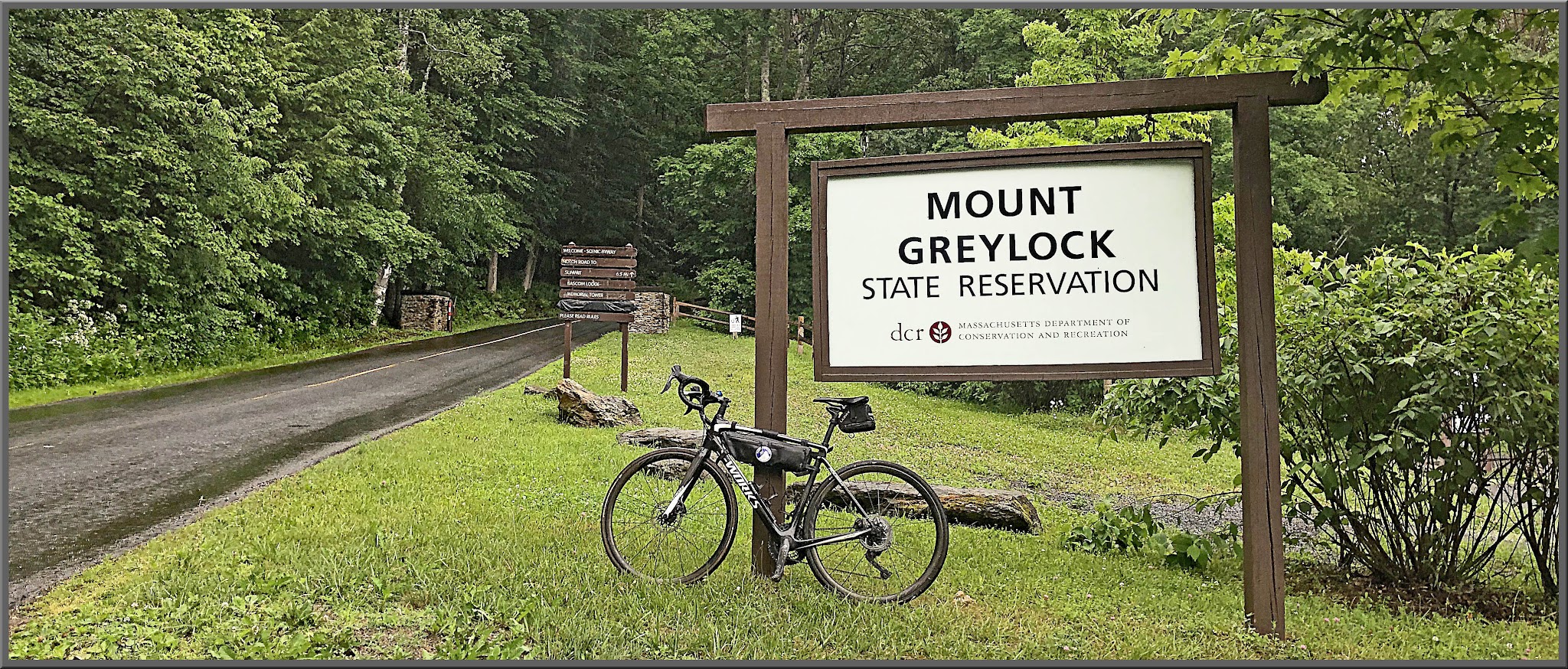Cycling Mt. Greylock, Massachusetts  - bike parked in front of Mount Greylock State Reservation sign