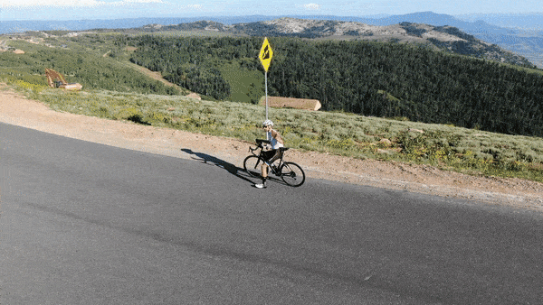 Summit Pass Road Sign with cyclist on Powder Mountain Utah bike climb.