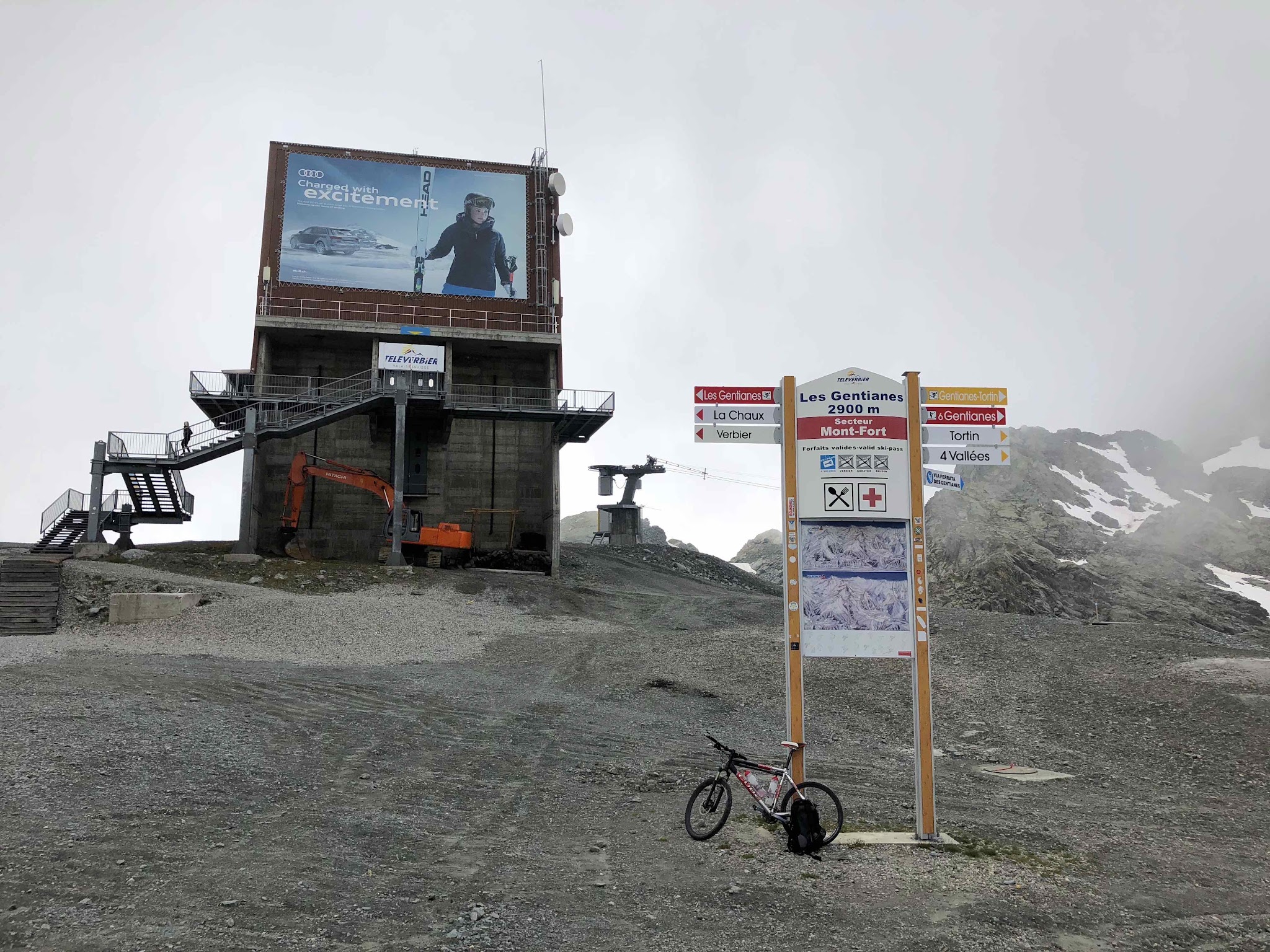 Bike climb highest bike climbs in Europe - bike against ski resort sign at top of Col des Gentianes